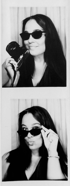 Two black-and-white photos of a woman with long dark hair, wearing sunglasses. In the first photo, she is smiling and holding a camera to her face. In the second photo, she is playfully adjusting her sunglasses and puckering her lips.