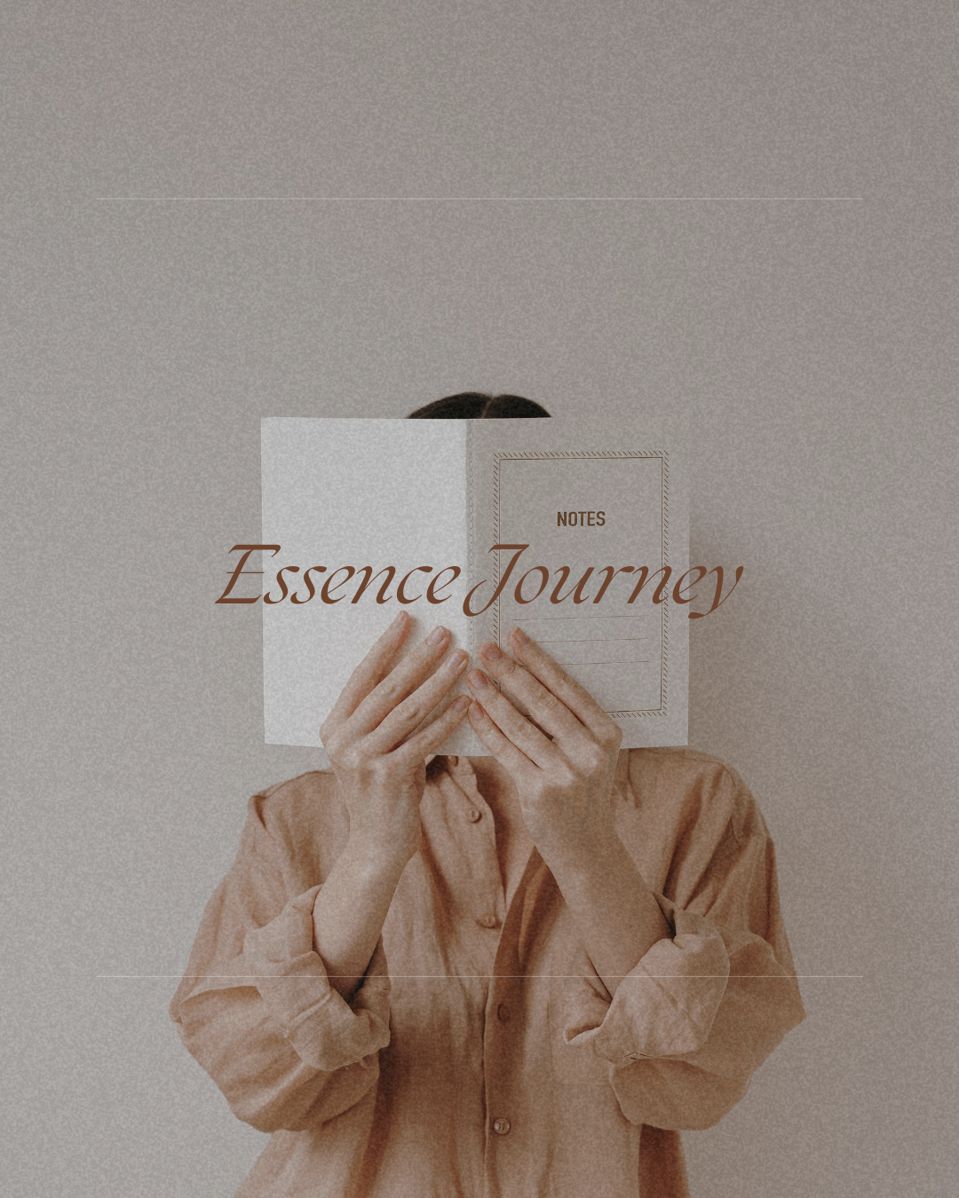Person holding an open notebook titled 'Essence Journey' in front of their face, wearing a beige shirt, against a plain wall background.