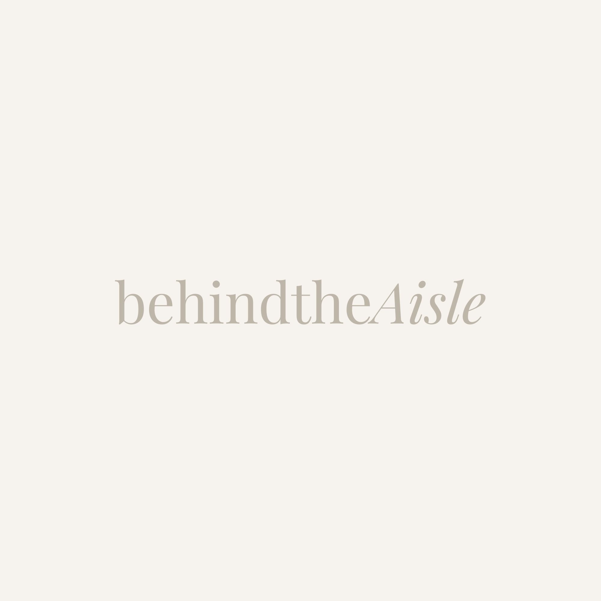 Text on a light background reading 'behindtheAisle' in lowercase, elegant font.
