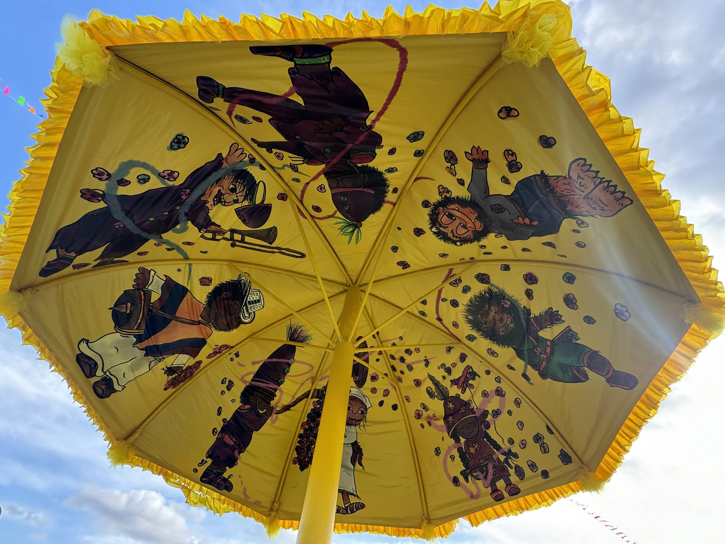 Mural interior Giant Yellow Umbrella sponsored by Expedia at Jazz & Heritage Festival in New Orleans, LA.