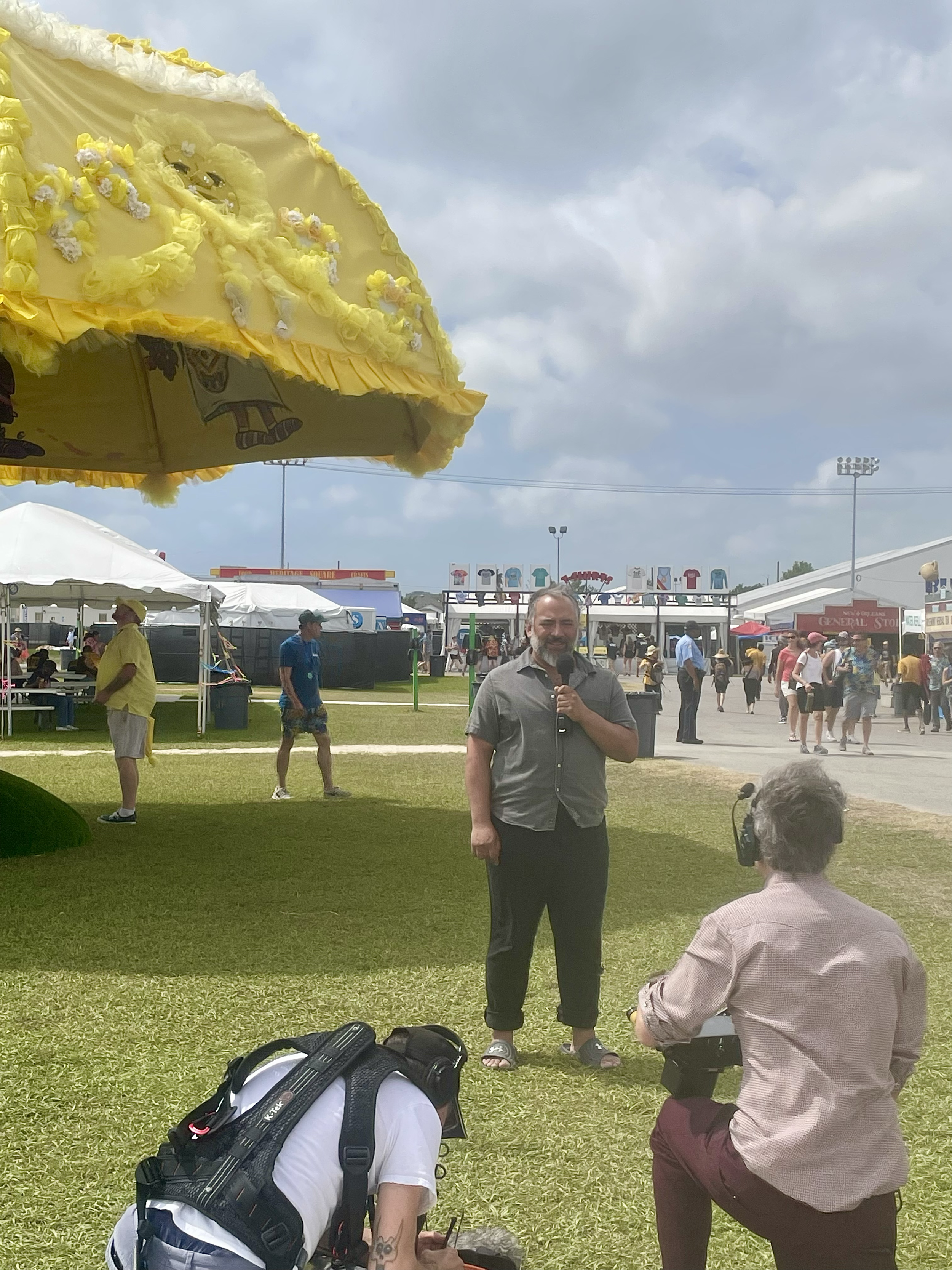 Basqo Bim in front of Giant Yellow Umbrella sponsored by Expedia at Jazz & Heritage Festival in New Orleans, LA.