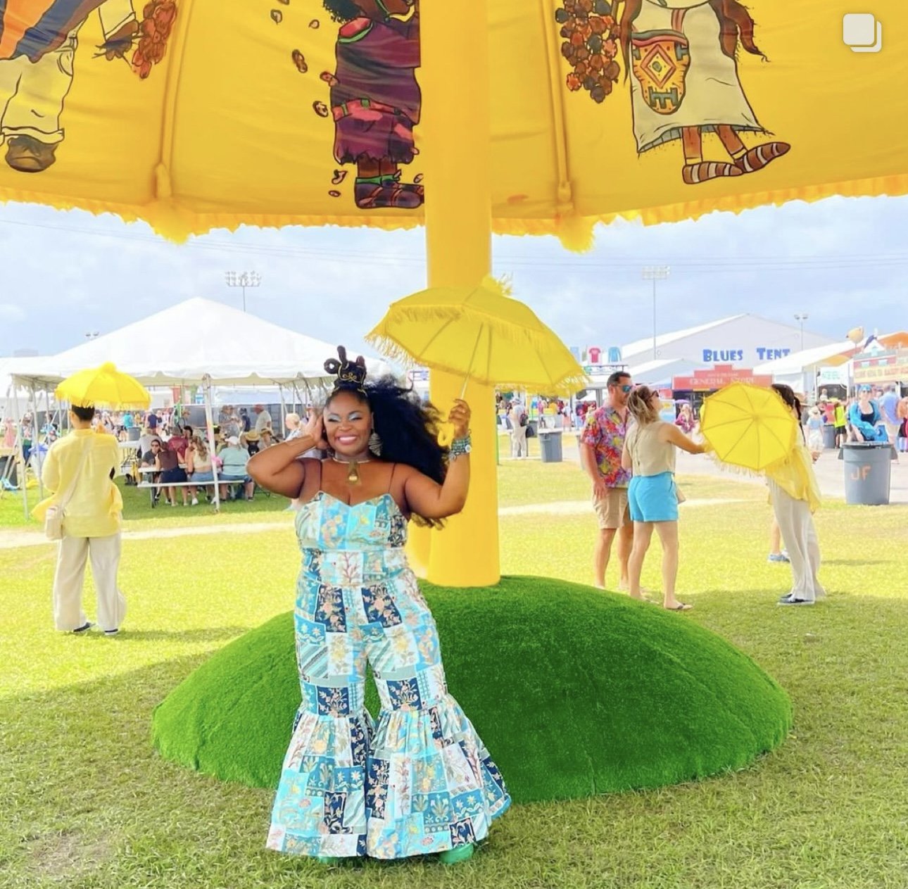 Tank and the Bangas in front of Giant Yellow Umbrella sponsored by Expedia at Jazz & Heritage Festival in New Orleans, LA.
