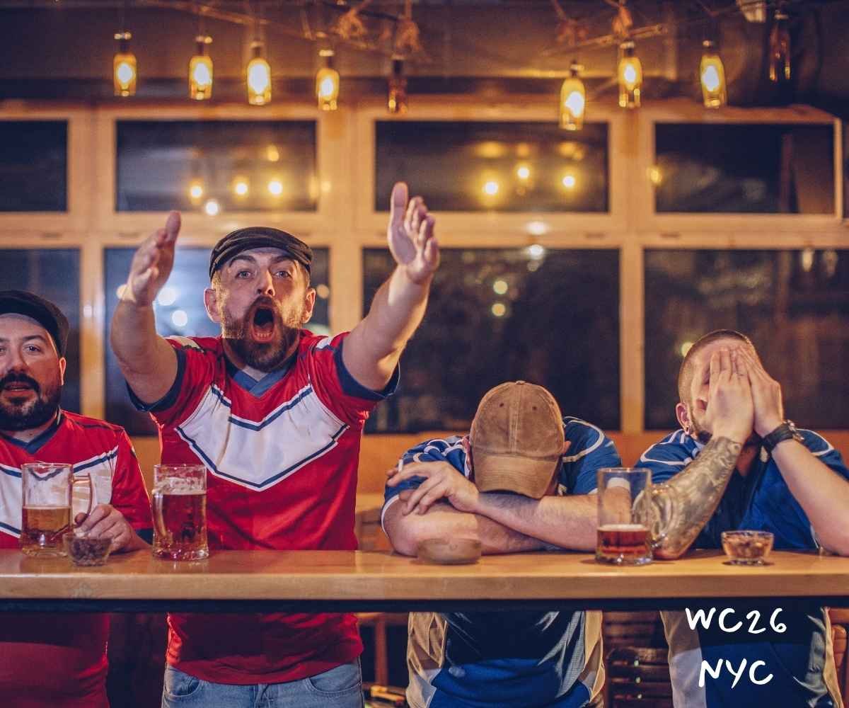 Patrons raising glasses and celebrating at the best football pubs on 9th Ave in New York City.