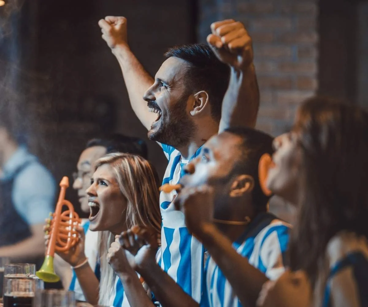 Massive crowd of Argentina football fans celebrating inside a top-rated Manhattan soccer bar near Penn Station during a World Cup match.