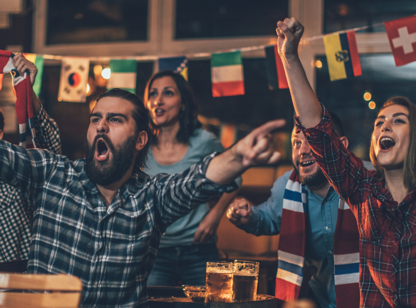 England supporters in Three Lions kits cheering intensely at an authentic international football factory in the Empire State Building district during a 2026 World Cup "Sound On" matchday.