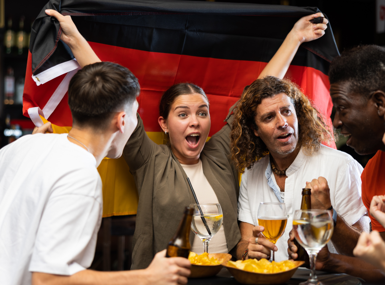 A diverse group of international football fans celebrating together at a premier New York City World Cup venue.