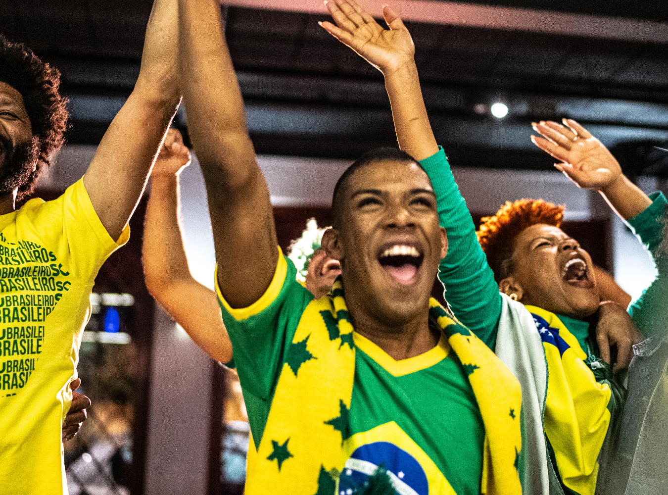 Passionate Brazil football fans waving flags and cheering during a high-volume matchday viewing event at the Bryant Park fan zone, a premier destination for global soccer culture in New York.