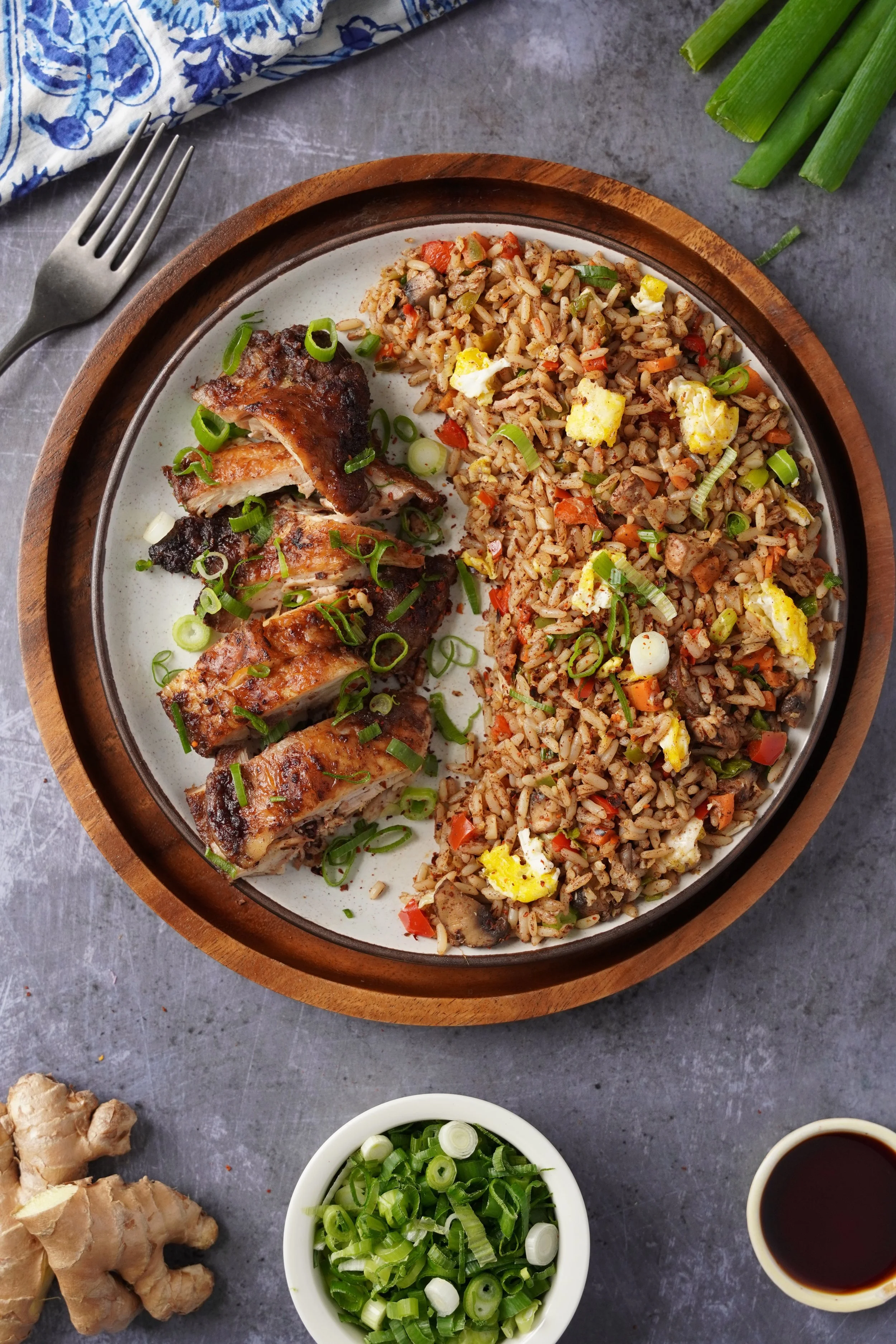 Detail of Fried Rice and Oven Fried Chinese Chicken with scallions on a ceramic plate