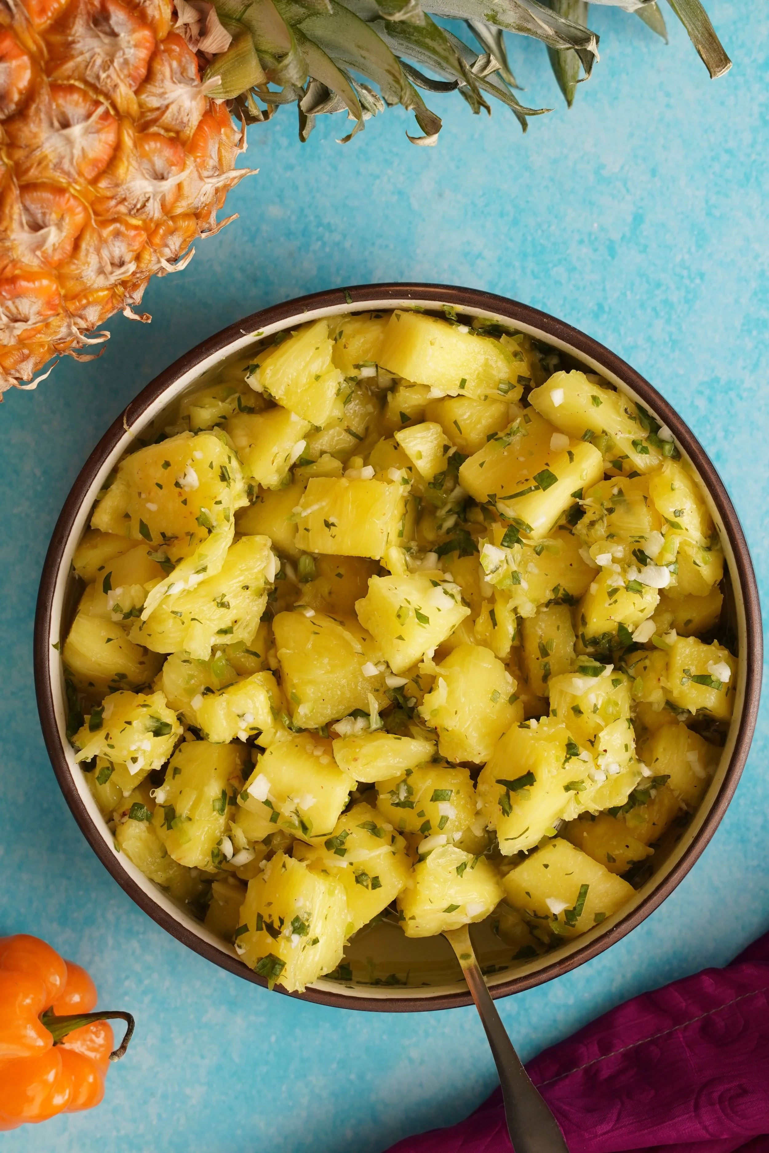 Pineapple Chow in a ceramic bowl on a blue surface