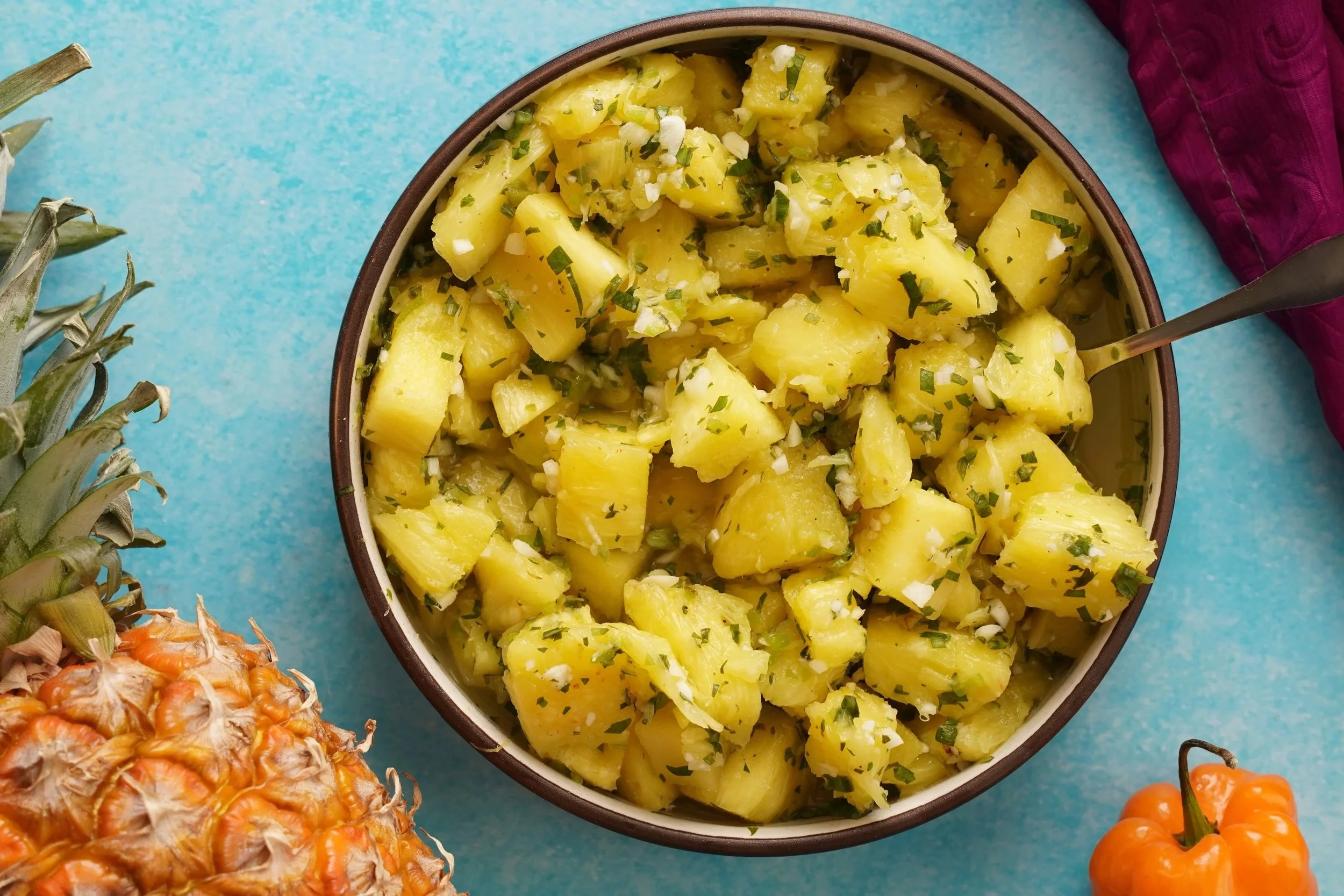 Pineapple Chow in a ceramic bowl on a blue surface