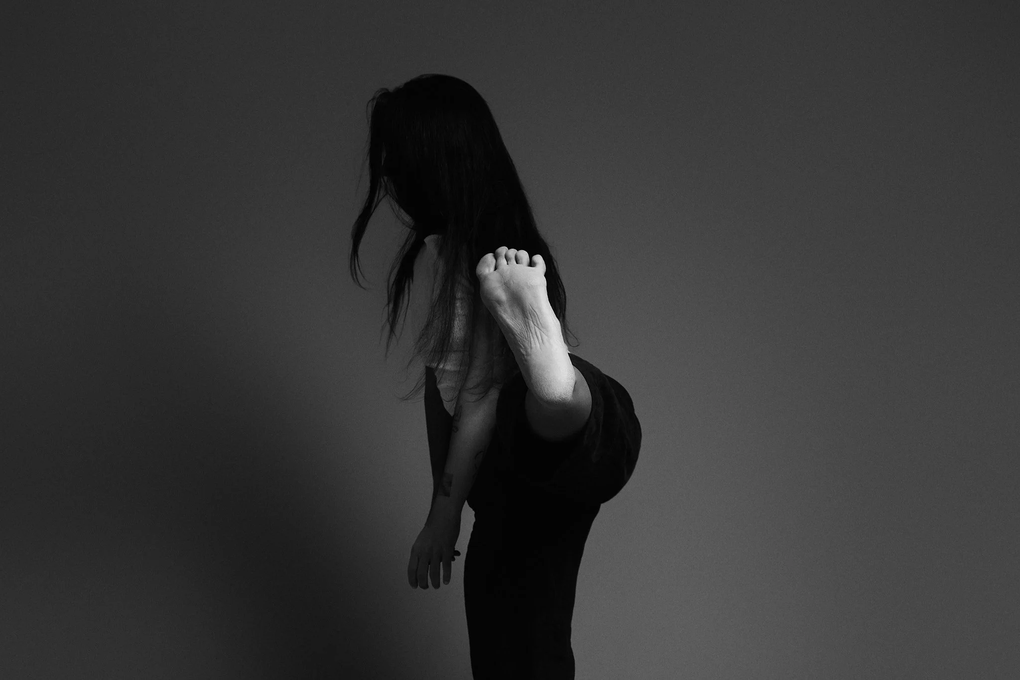 Woman in slow, embodied movement practice.