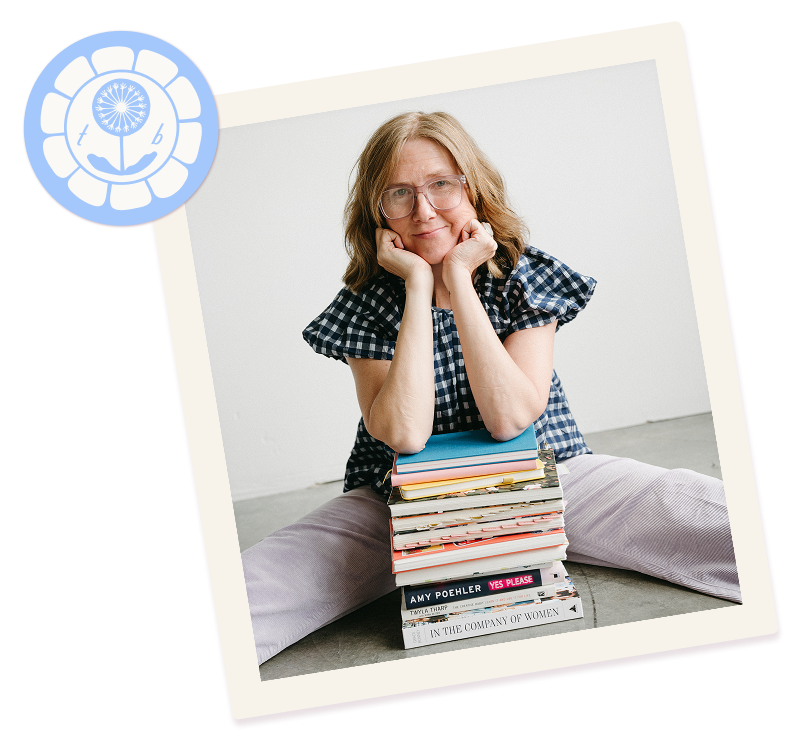 coach tammie bennett has her head propped on her arms which are resting on a pile of books