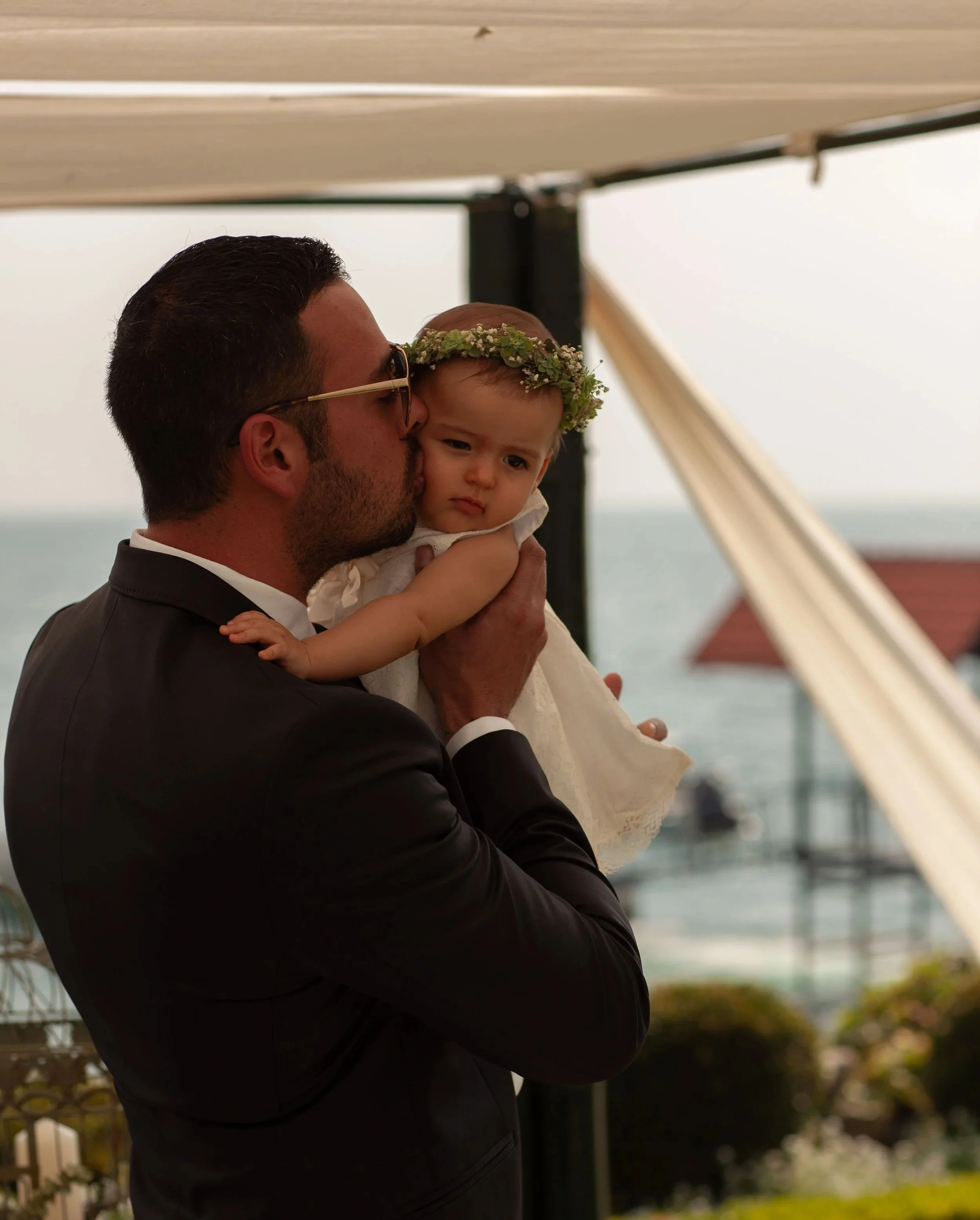 candid wedding moment between groom and daughter filled with emotion
