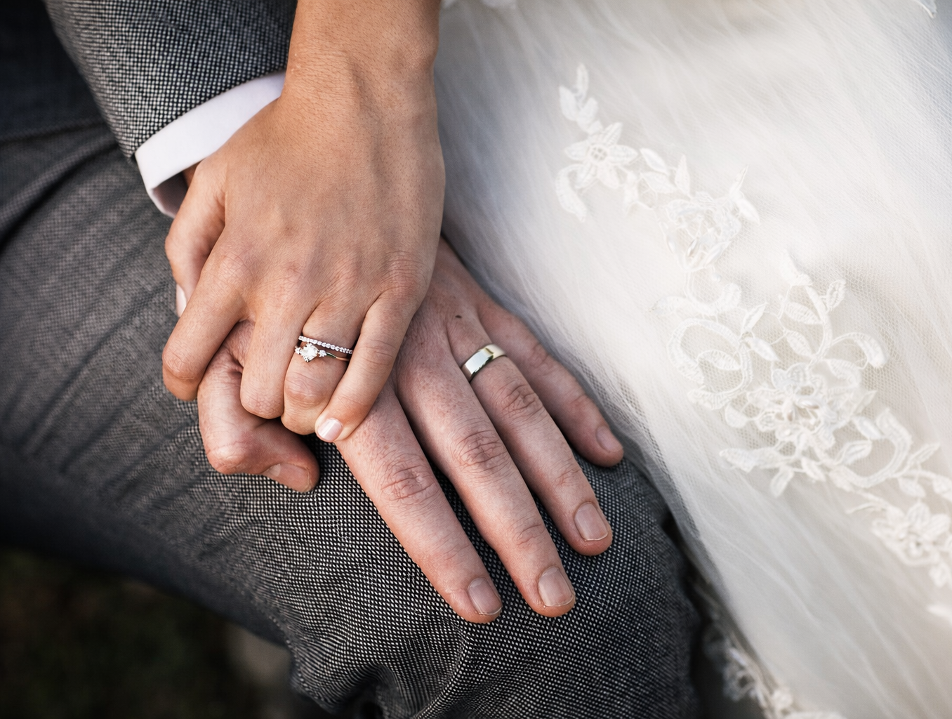 wedding rings stacked with diamonds on reflective surface