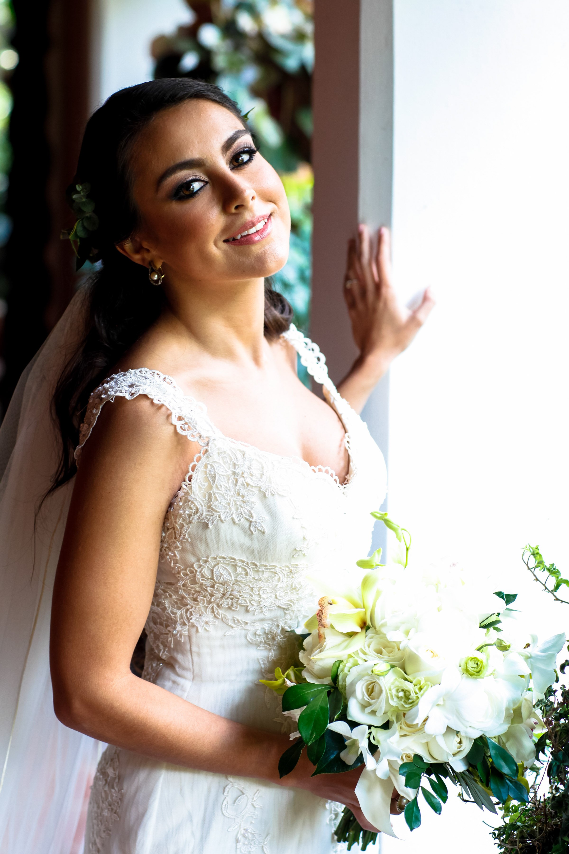 A luminous close-up captures glowing skin, soft waves, and refined makeup, emphasizing natural bridal beauty.