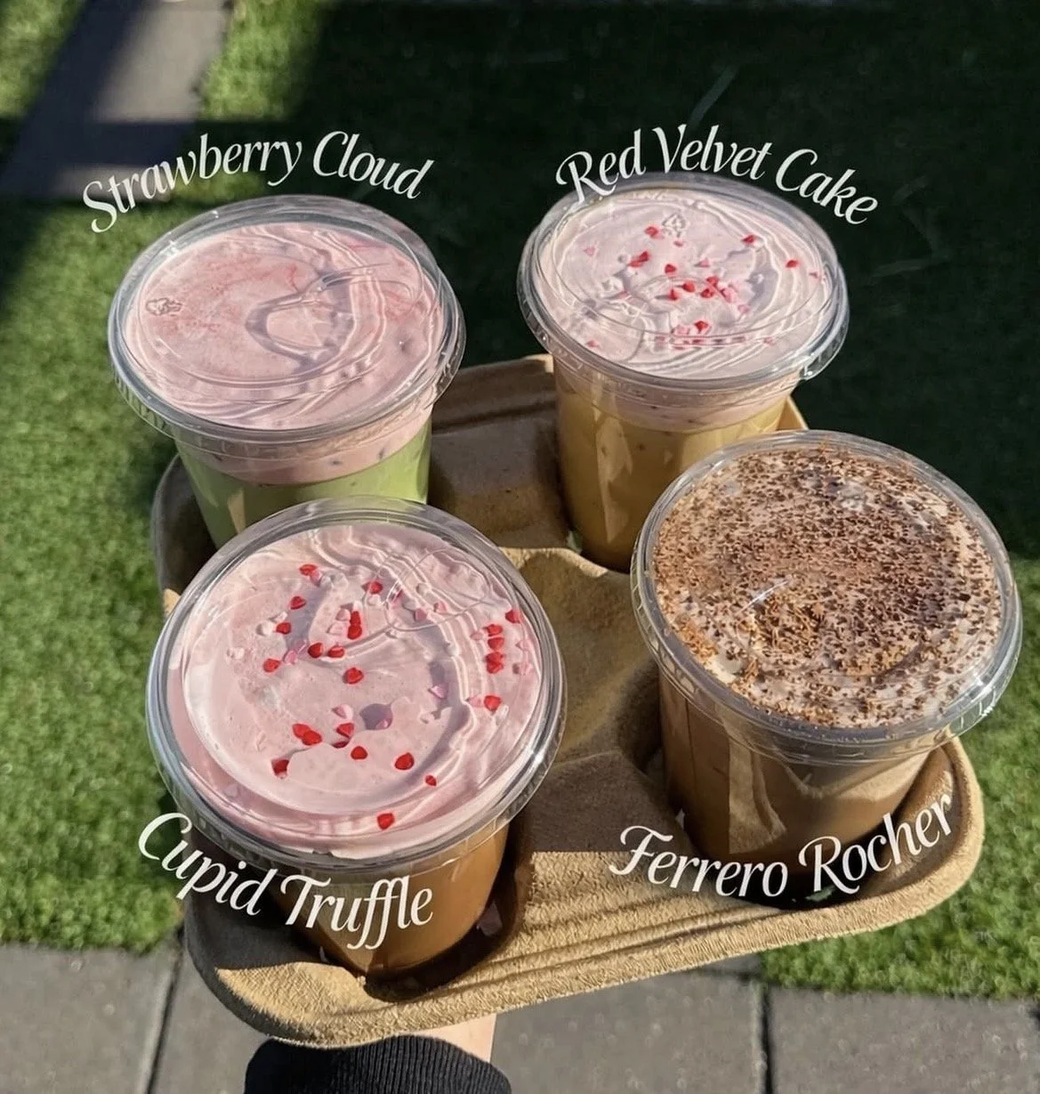 Red Bicycle Nashville offers seasonal favorites, choose toppings like sprinkles or heart-shaped sugar confetti. The drinks are labeled from top left clockwise as Strawberry Cloud, Red Velvet Cake, Ferrero Rocher, and Cupid Truffle. Red Bicycle Coffee