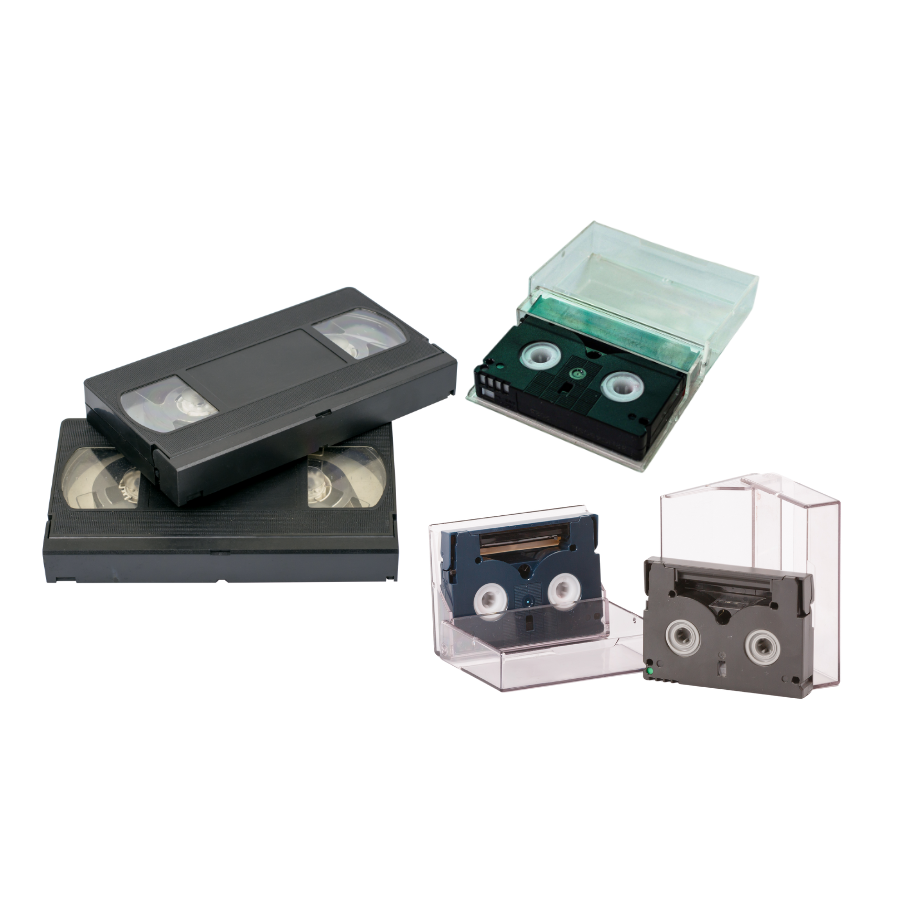 Various colorful VHS cassette tapes, some in cases, stacked on a surface.