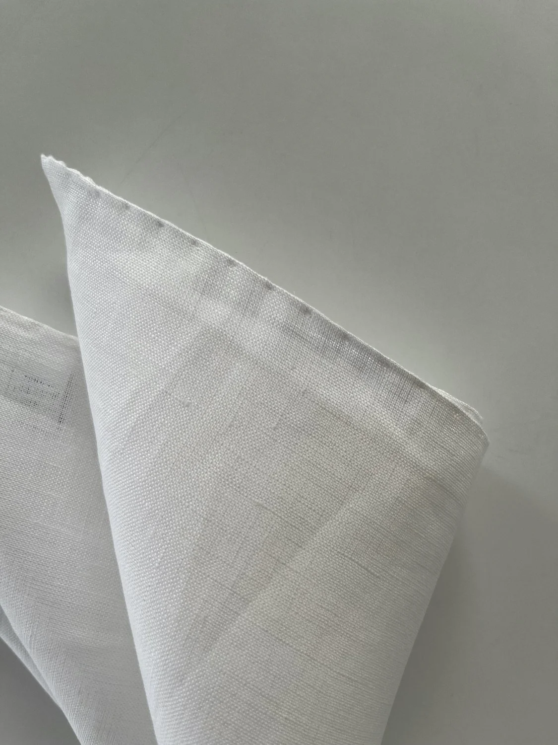 White linen pocket square, with hand-rolled edges
