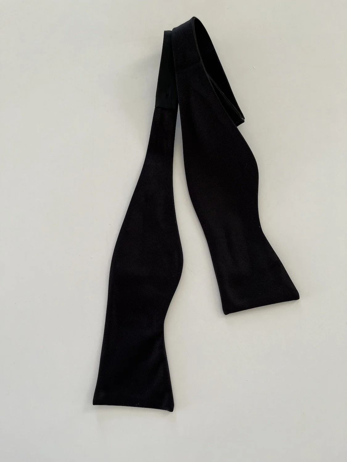 This is a large, black, grosgrain, butterfly, bow tie.  It is self-tied.