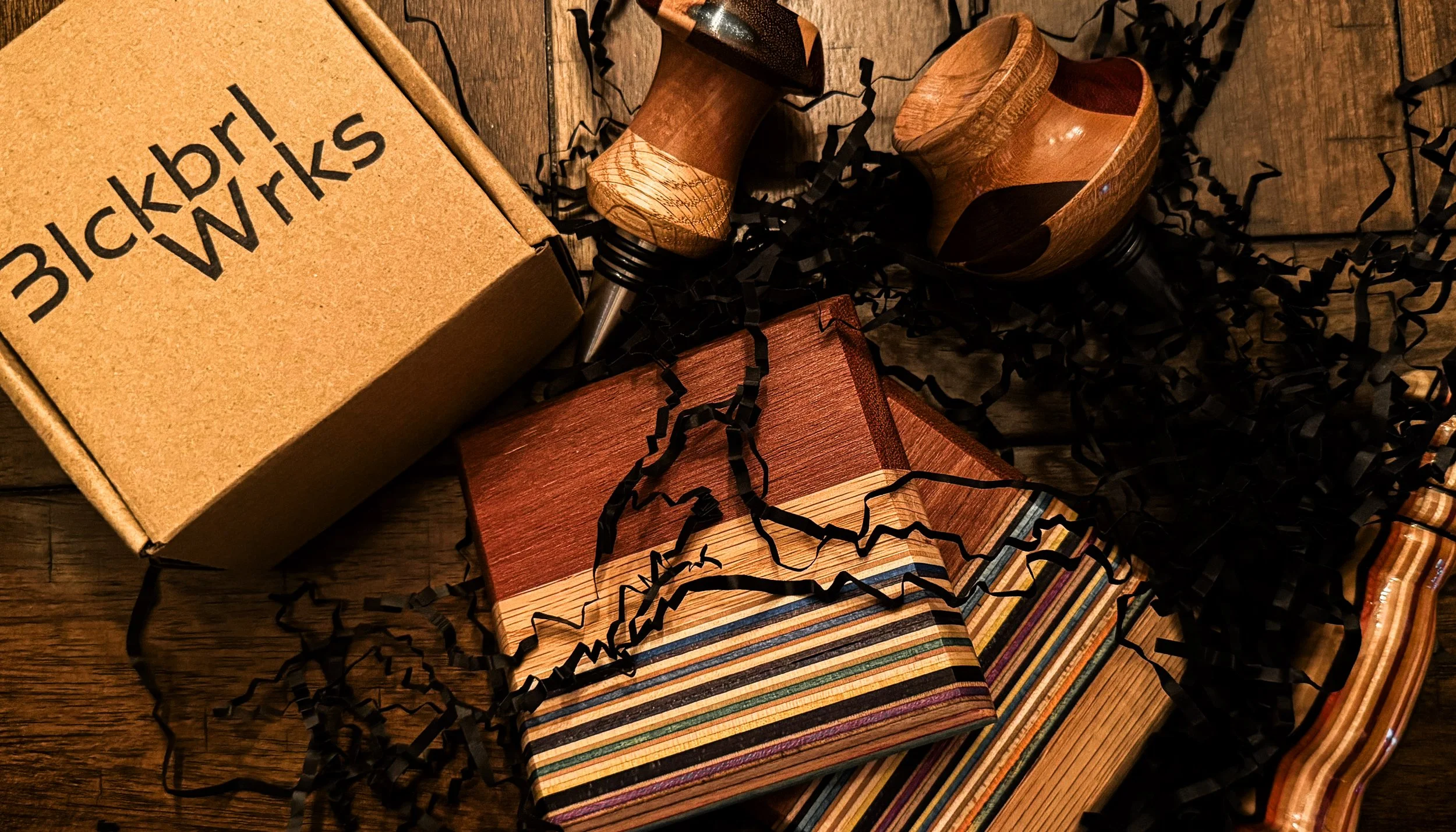 Handcrafted Blackburl Works gift set featuring hardwood bottle stoppers, coaster set, bottle opener, and branded gift box.