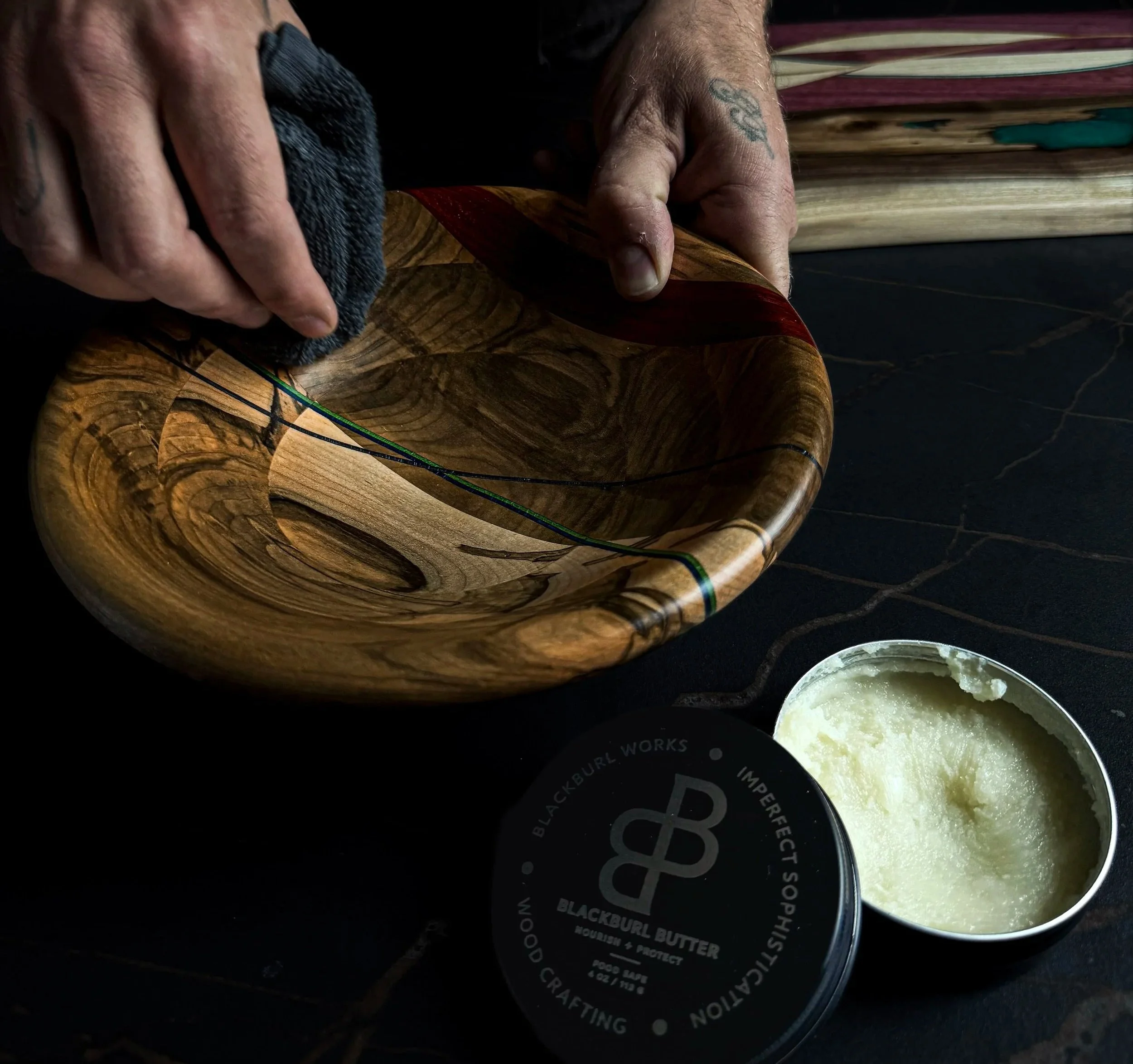 Hand applying Blackburl Butter wood conditioner to a handcrafted hardwood bowl during the finishing process at Blackburl Works in Fernie, British Columbia, Canada. Each one-of-one bowl is carefully hand finished to nourish the wood.