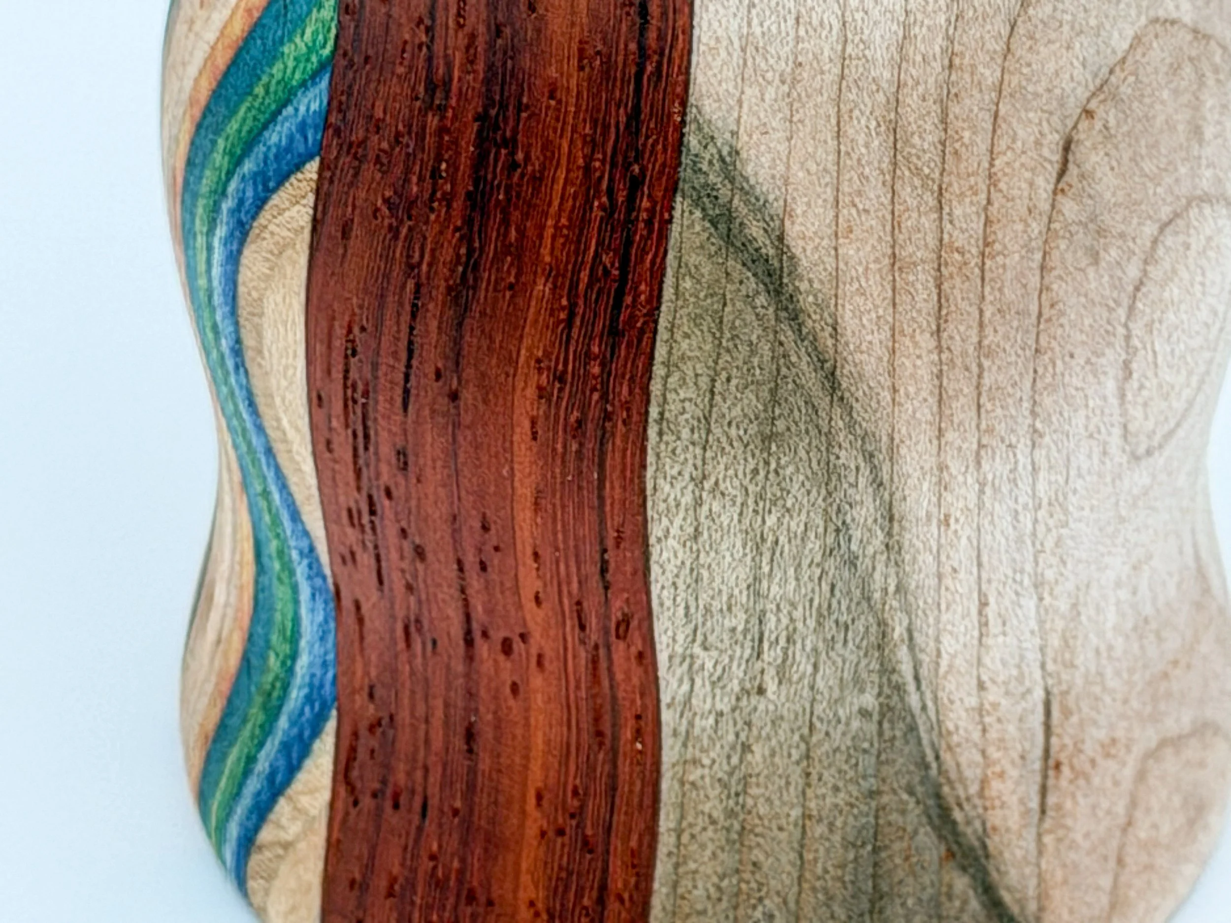 Close-up of a wooden surface with recycled skateboard stripes on the left side.