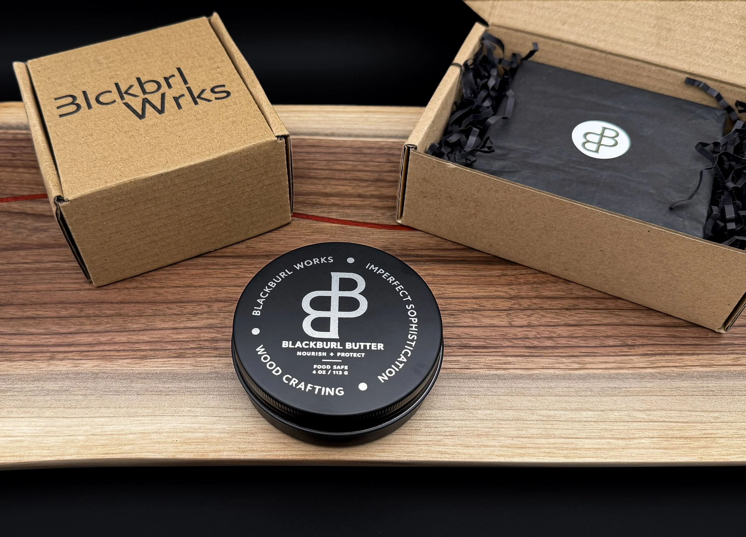 Blackburl Butter food-safe wood conditioner tin with premium gift box packaging on a handcrafted serving board.
