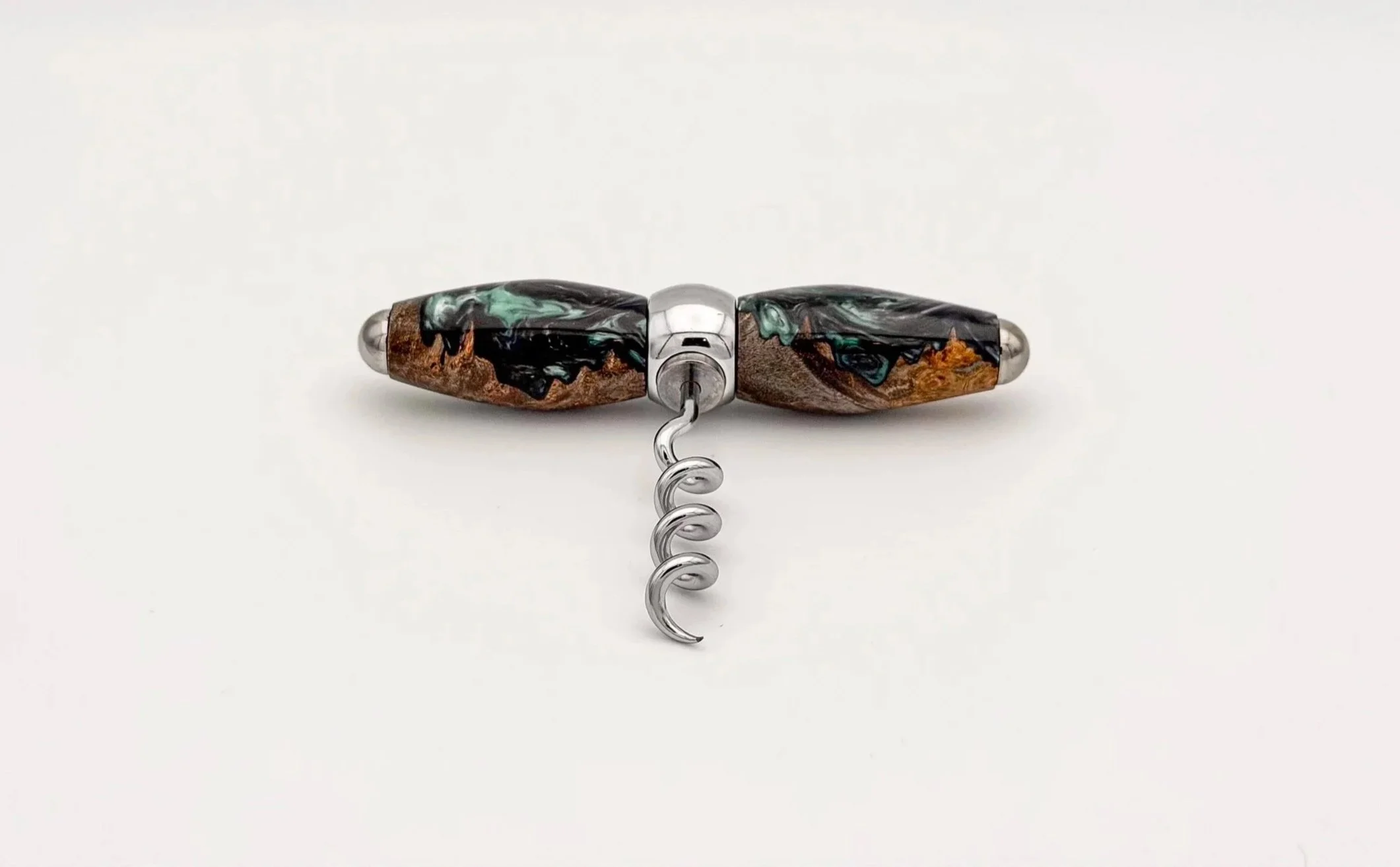 Close-up of a corkscrew with a black, brown, green, and blue marbled handle on a white background.