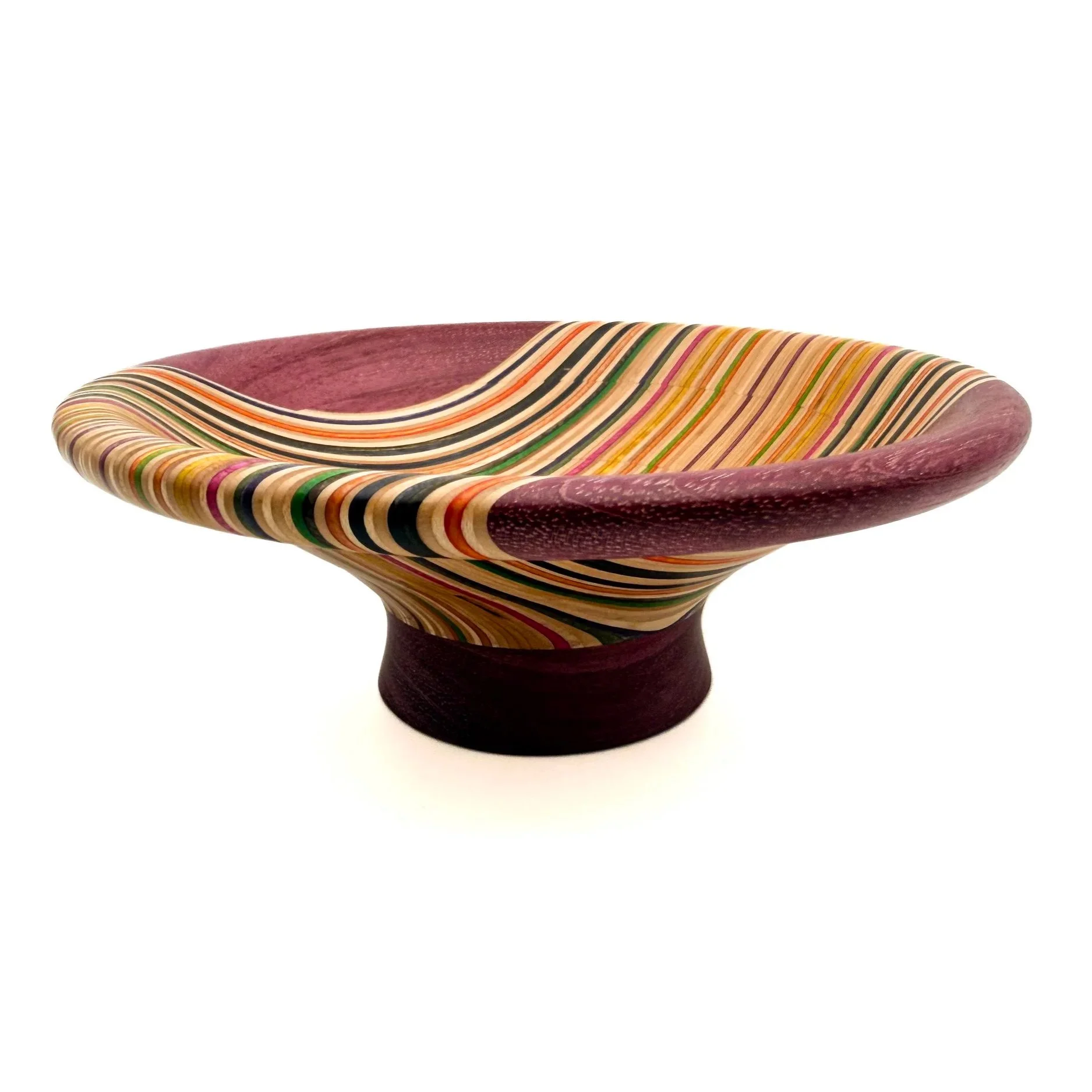 Handcrafted decorative bowl made from recycled skateboard veneers with flowing multicolored grain by Blackburl Works.