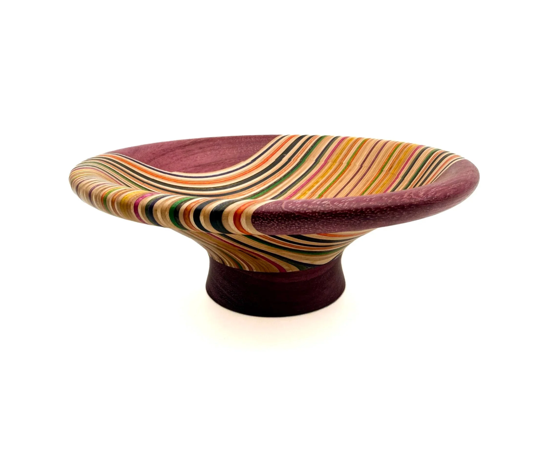 Handcrafted decorative bowl made from recycled skateboard veneers with flowing multicolored grain by Blackburl Works.
