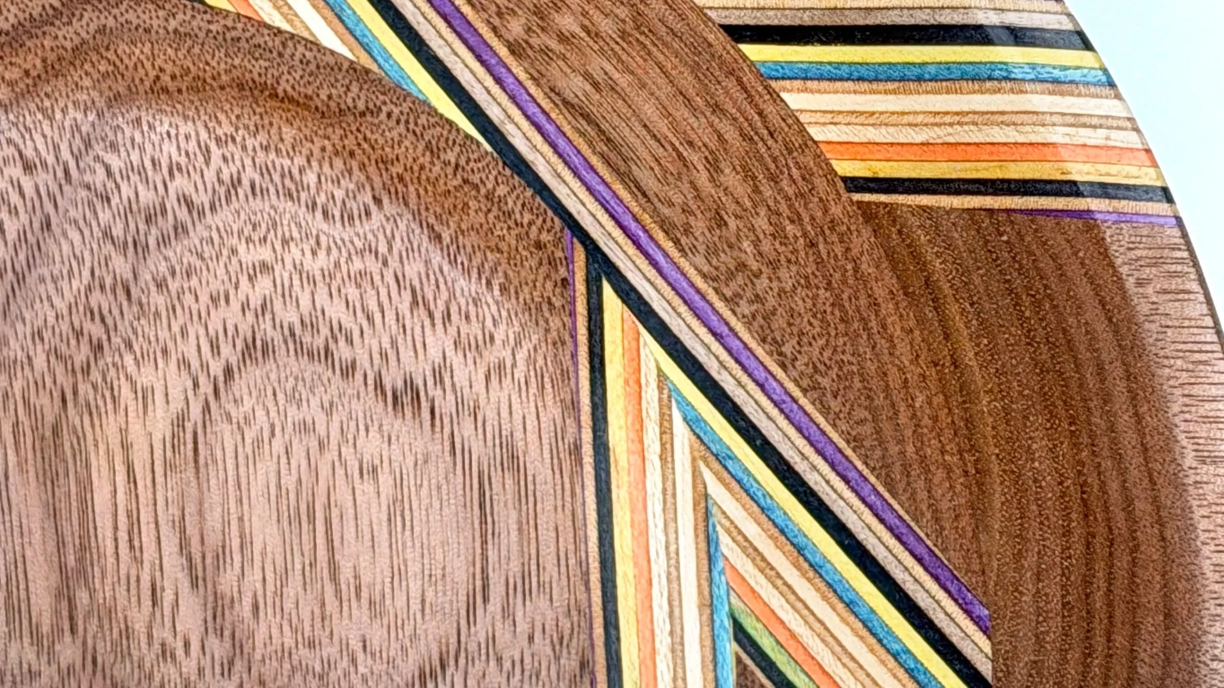 macro close up of a walnut wooden bowl with recycled skateboard wood. made by blackburl works