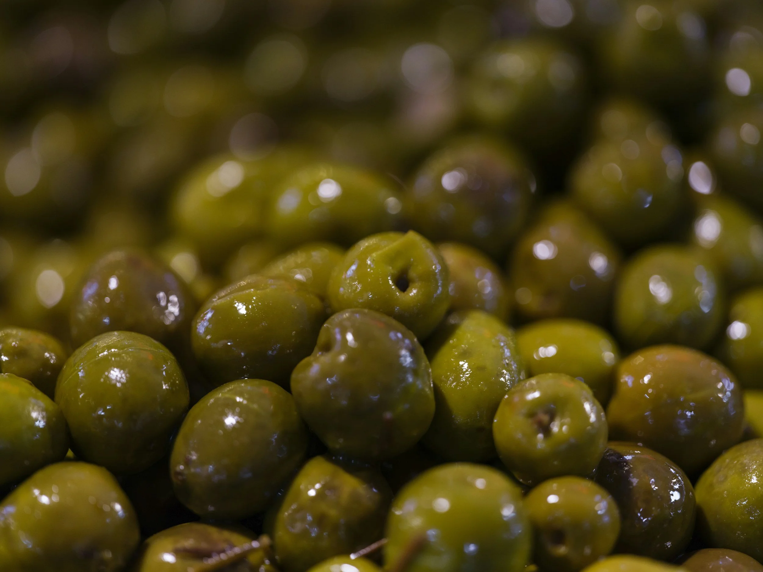 Close-up of numerous green olives.