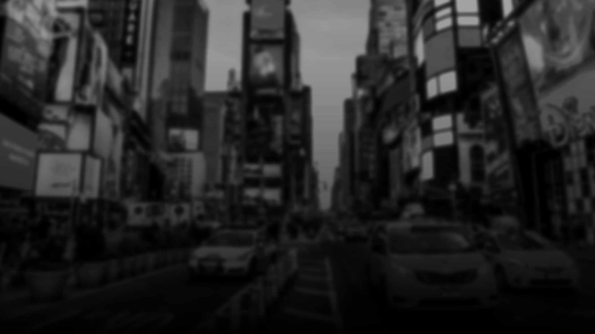 A busy city street with cars and buses on the road, surrounded by tall buildings with digital billboards and advertisements. The Five Unfiltered.
