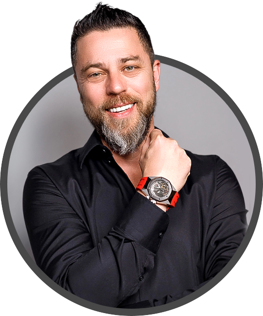 Roman Sharf wearing a black dress shirt, smiling, and showing a red and red wristwatch.