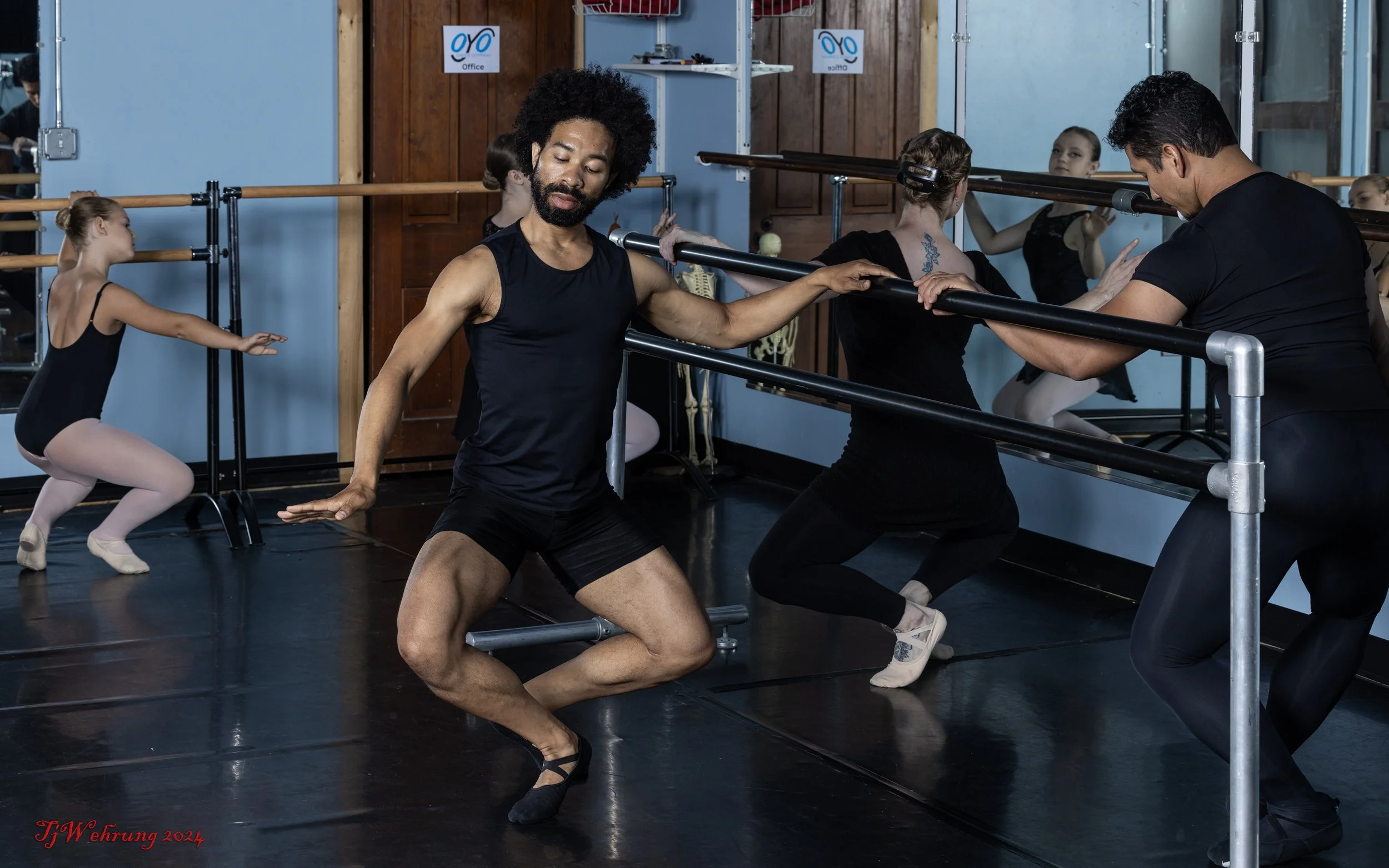 Multiple adult ballet dances practicing