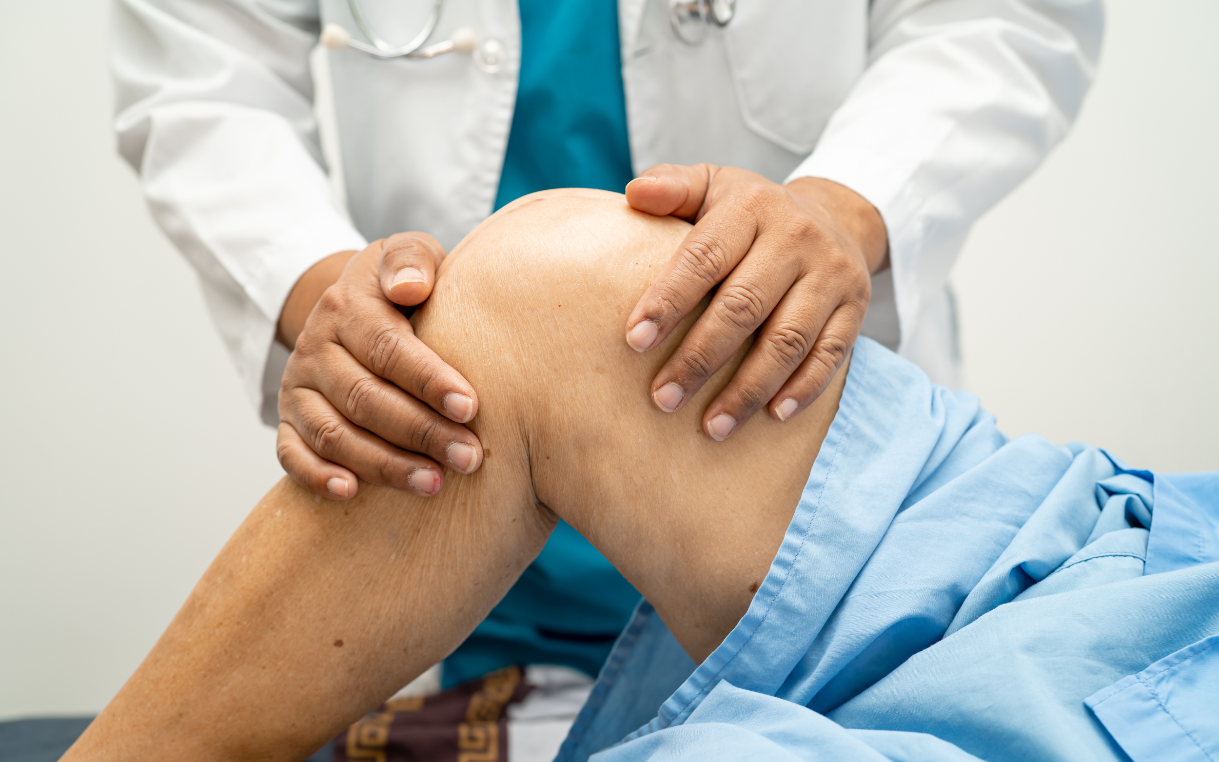 Doctor working on person's knee