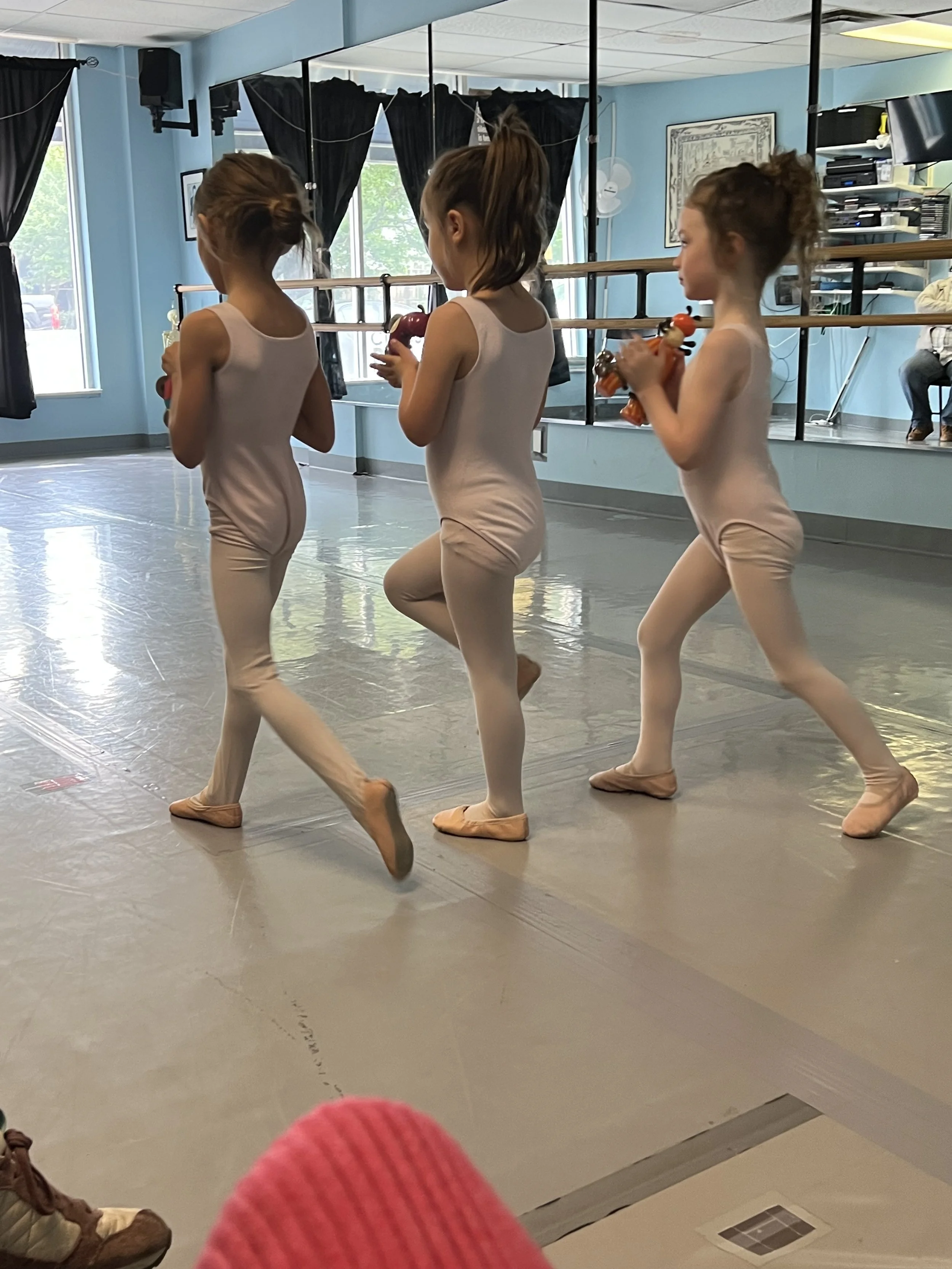 Three girls practicing their dances.