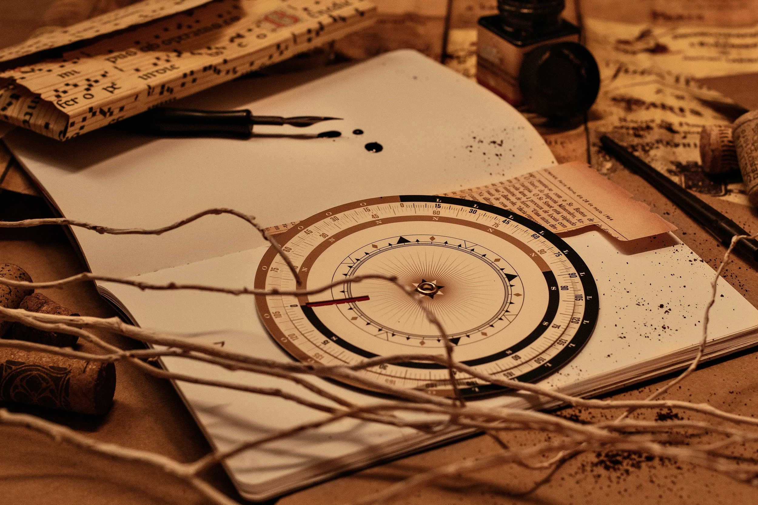 Vintage astrolabe and fountain pen on an antique writing desk