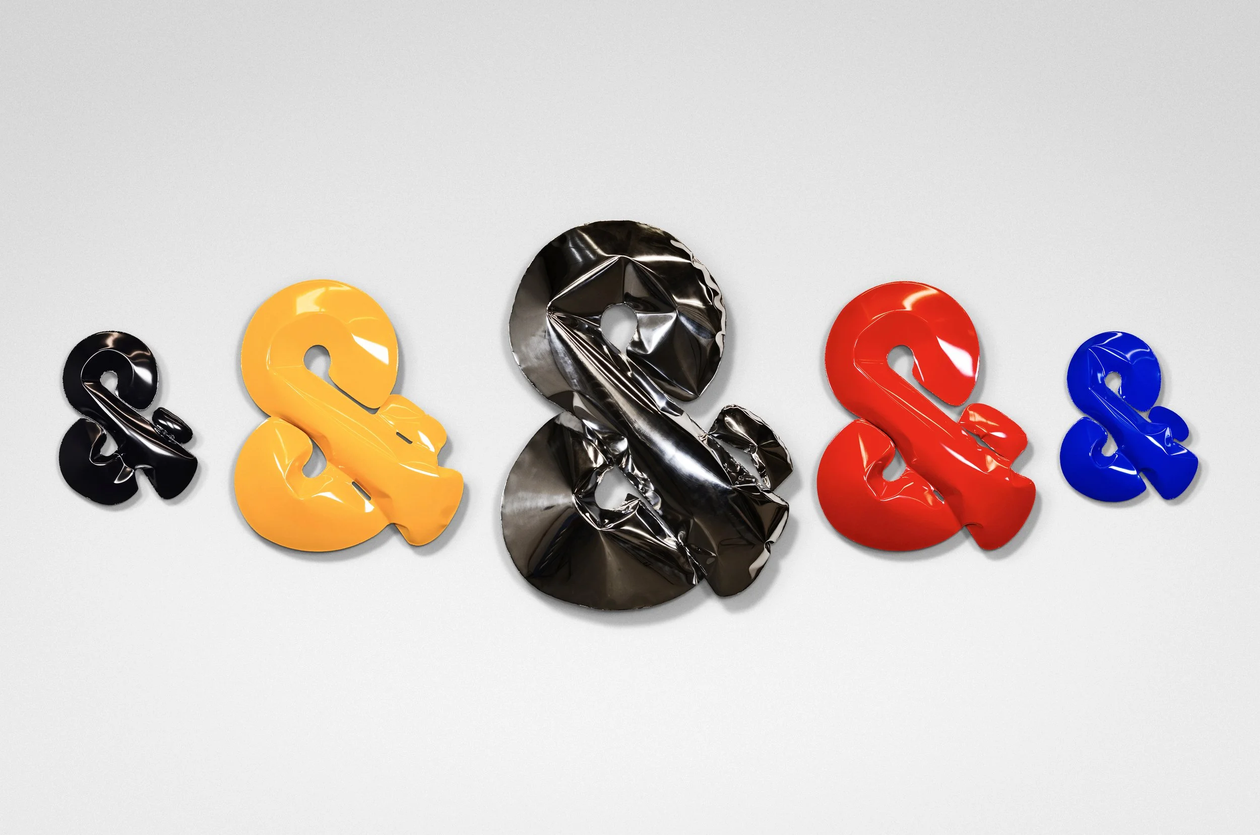 Colorful array of steel and stainless steel ampersand hydroformed sculptures. Polished to mirror finish, and powdercoated vibrant colors.