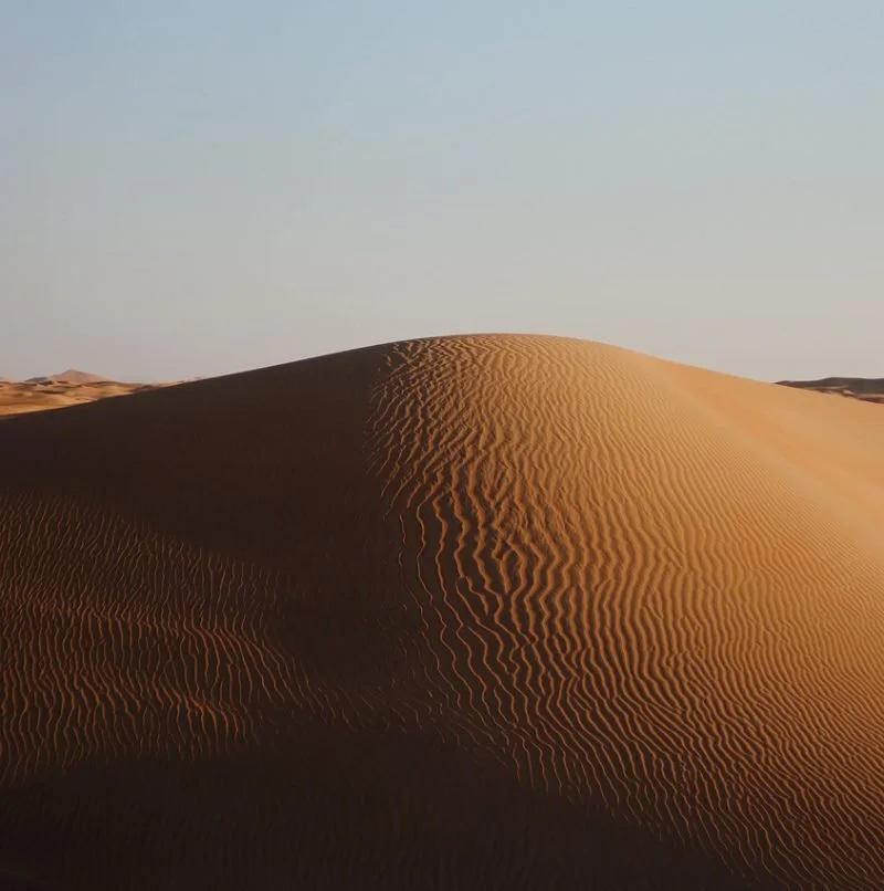 Desert landscape and sand dune with wavy lines.
