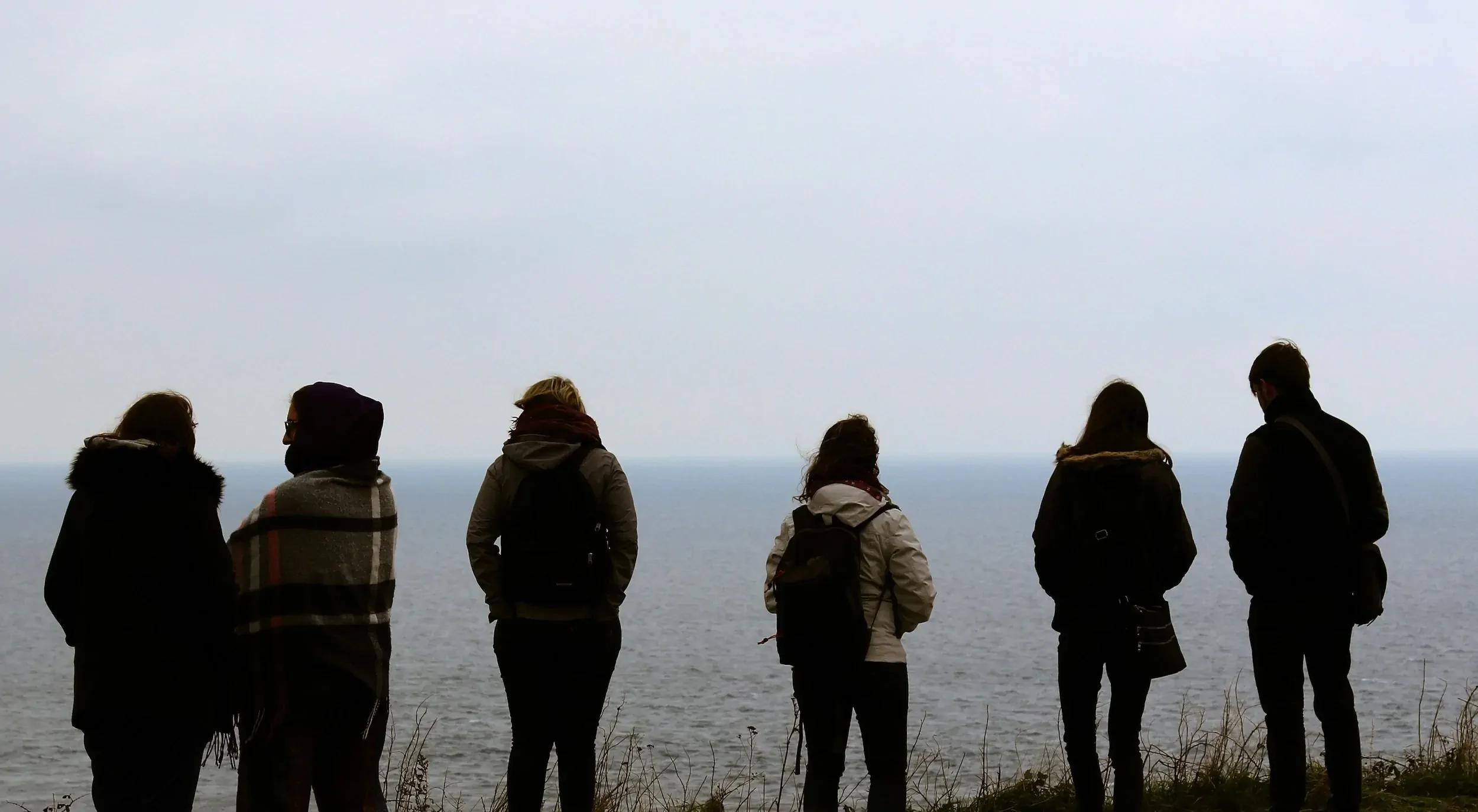 Colleagues standing by lake