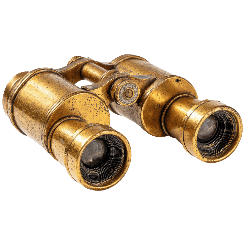 Vintage brass binoculars with black interior lenses isolated on a white background.