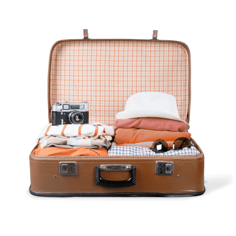 Open vintage brown suitcase filled with folded clothes, a camera, sunglasses, and a white hat against a black background.