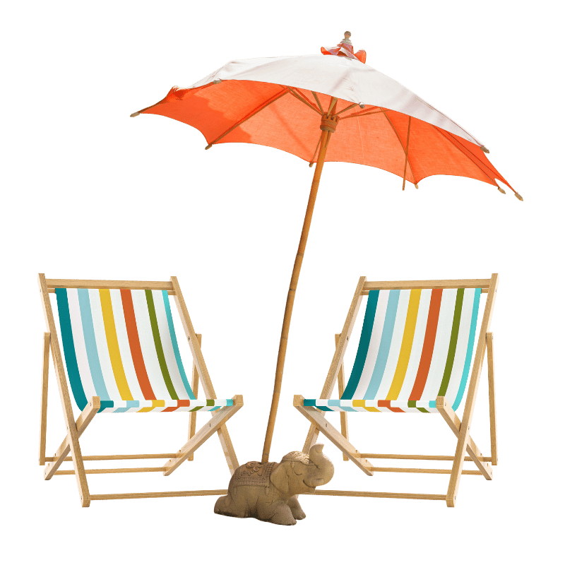 Beach chairs with a rainbow striped fabric, an orange and white umbrella with a small decorative figure on top, and a stone elephant sculpture at the base of the umbrella.