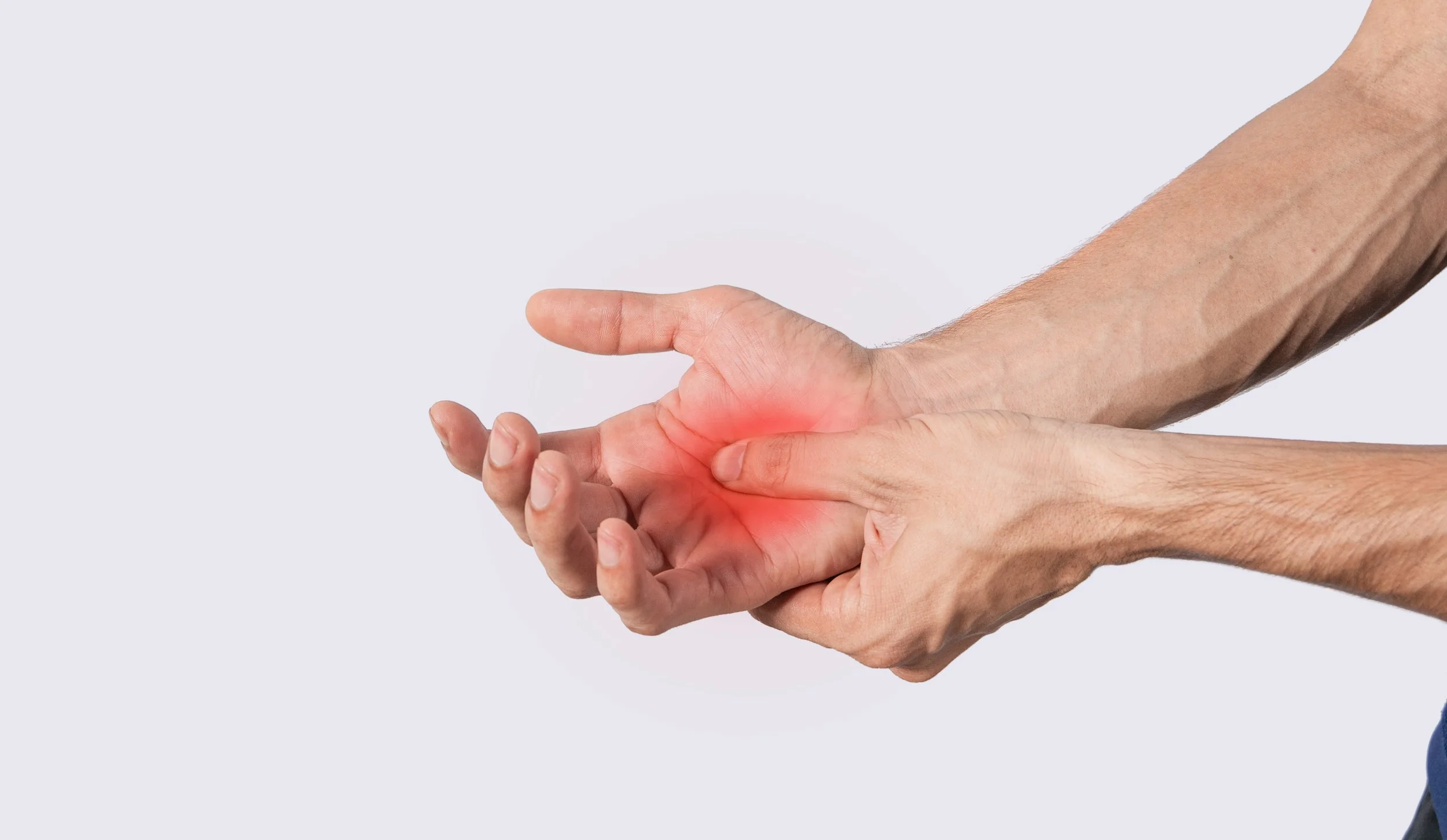 A man holding his open palm with a bright red pain indicator overlay, seeking specialized physical therapy for hand and finger pain in Manhattan.