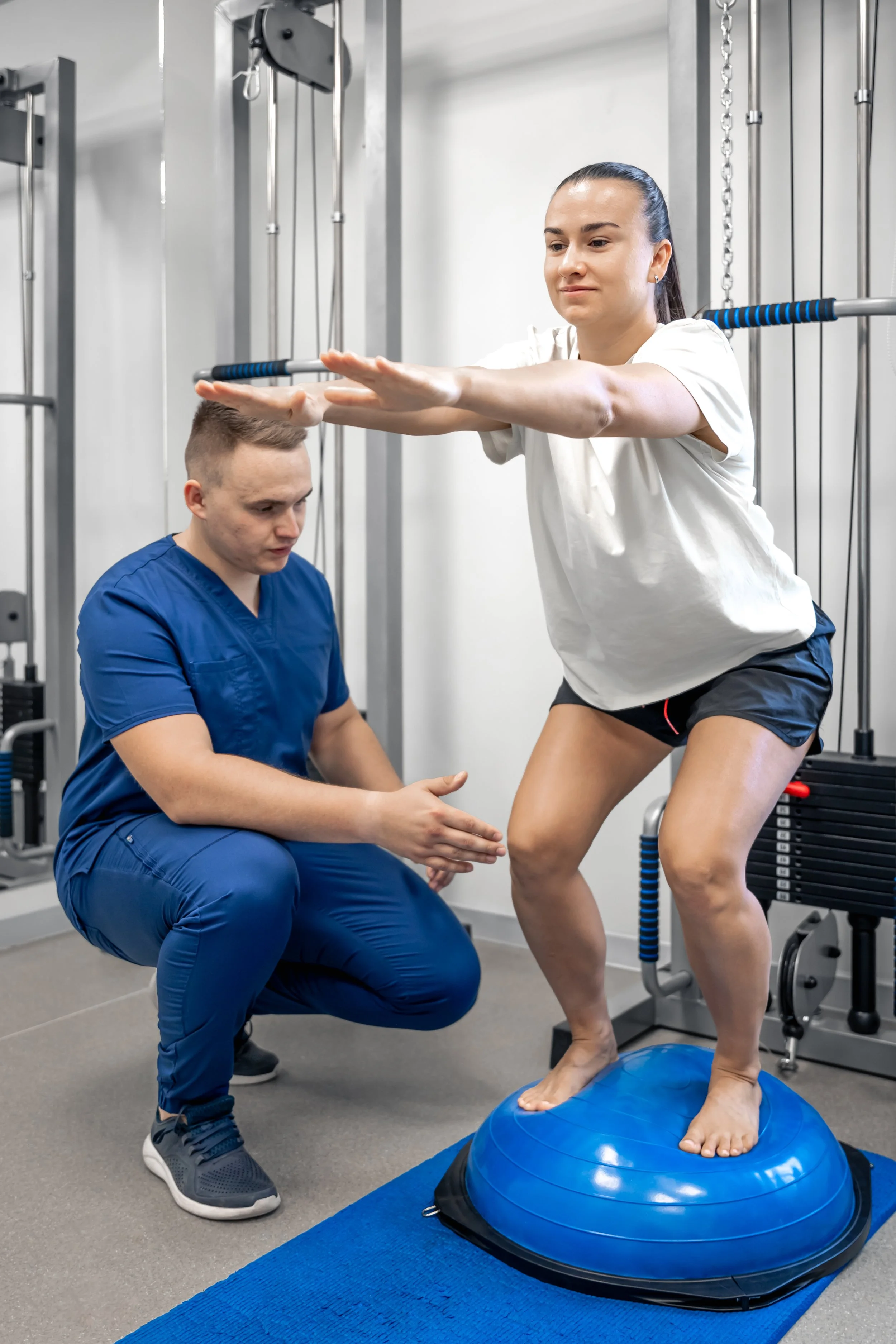 A professional physical therapist perform manual stabilization and guided balance retraining exercises for a patient with vestibular dysfunction.