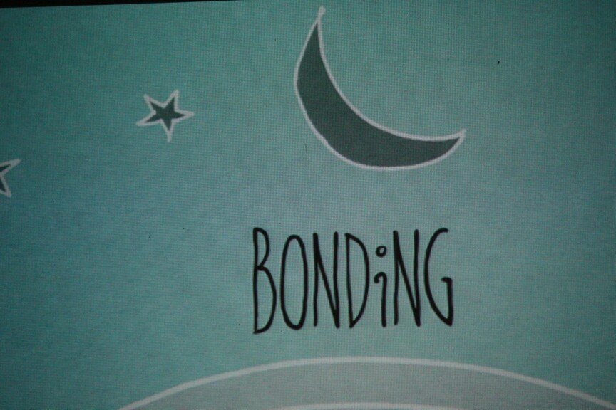 A light blue background with star and moon illustrations and the word "BONDING" written in black capital letters.