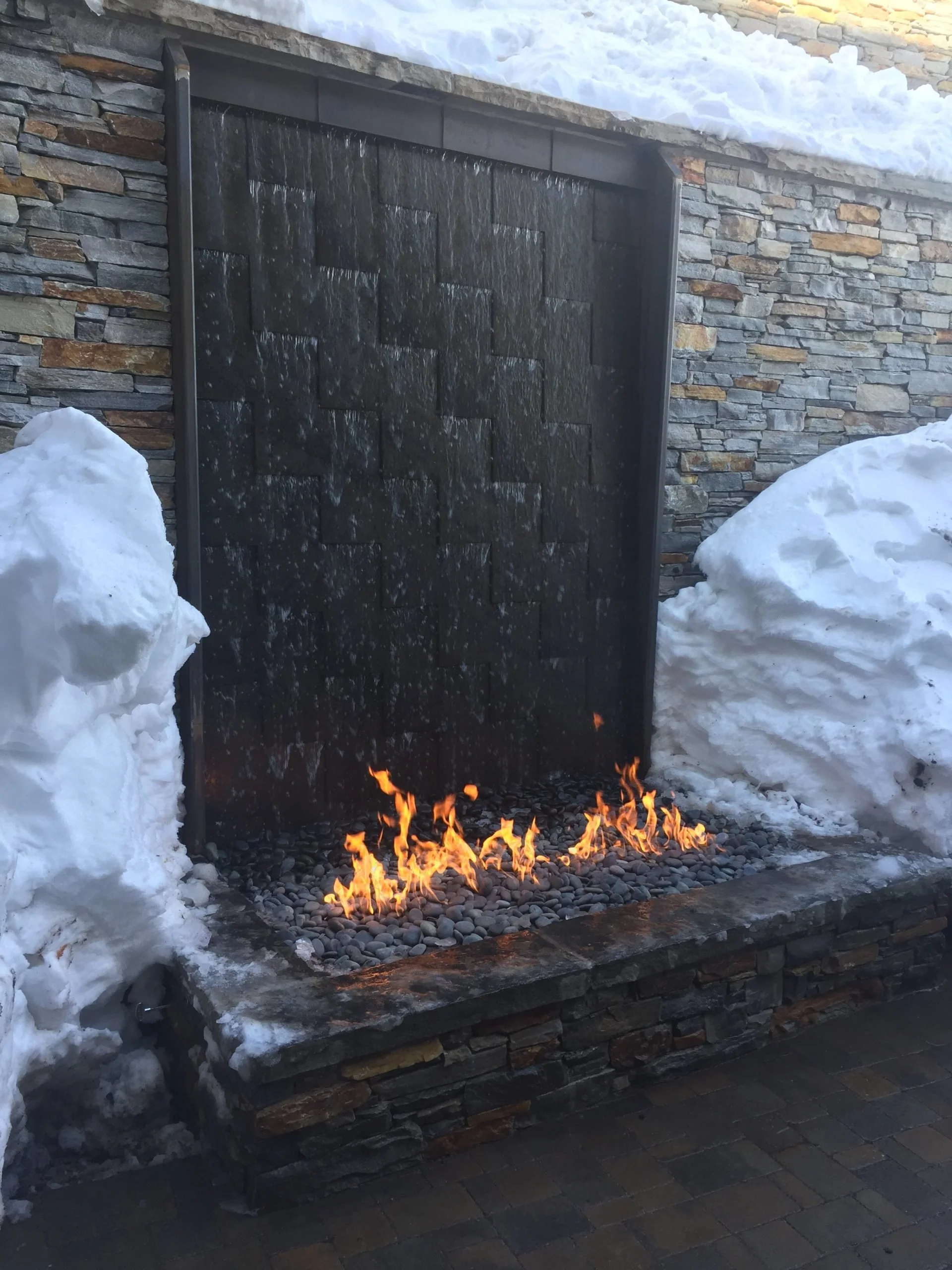 Steel water feature with fire at base