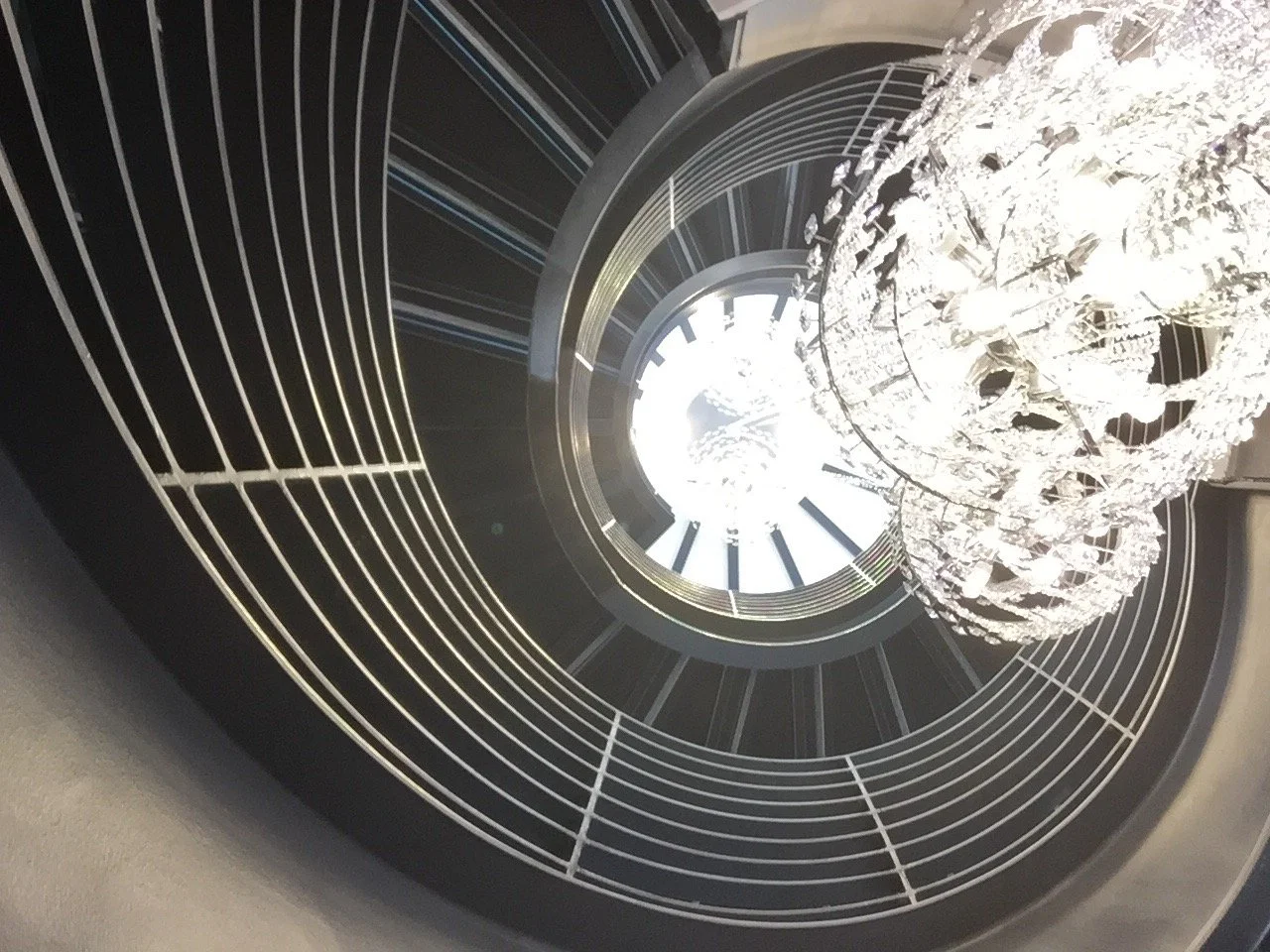 View through center of steel stair highlighting lighting and rails
