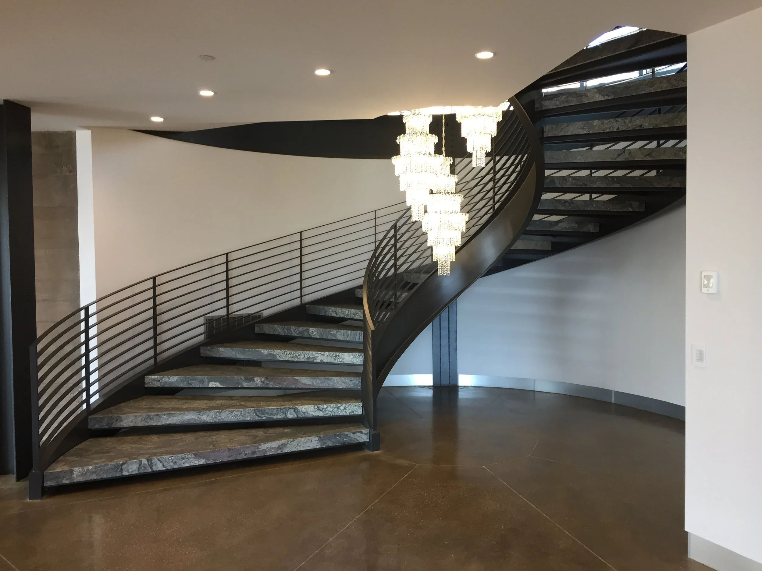 Lower level of custom steel curved stair